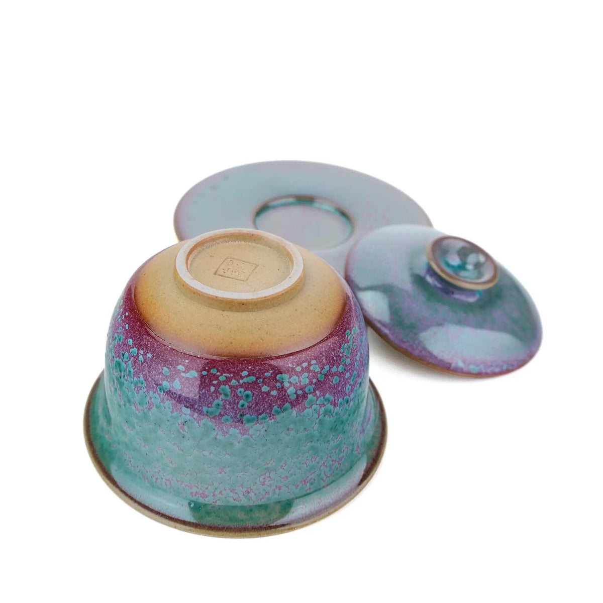Huaning gaiwan #501 bowl upside down beside its saucer and lid, showing the unglazed base and stamped seal