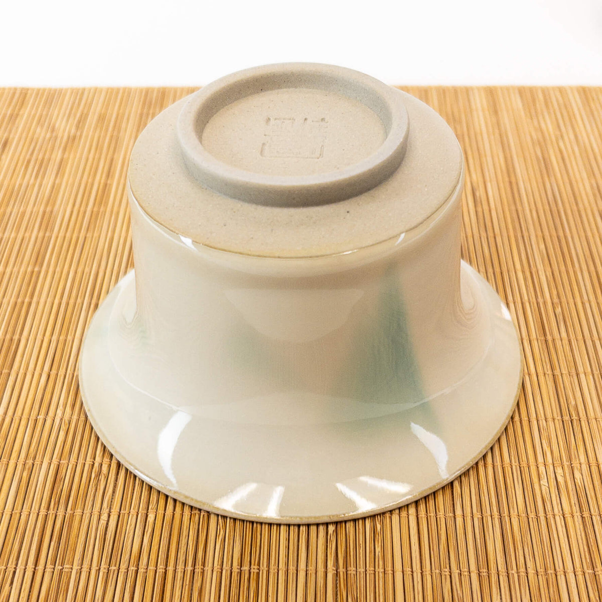 underside of gaiwan on a bamboo mat