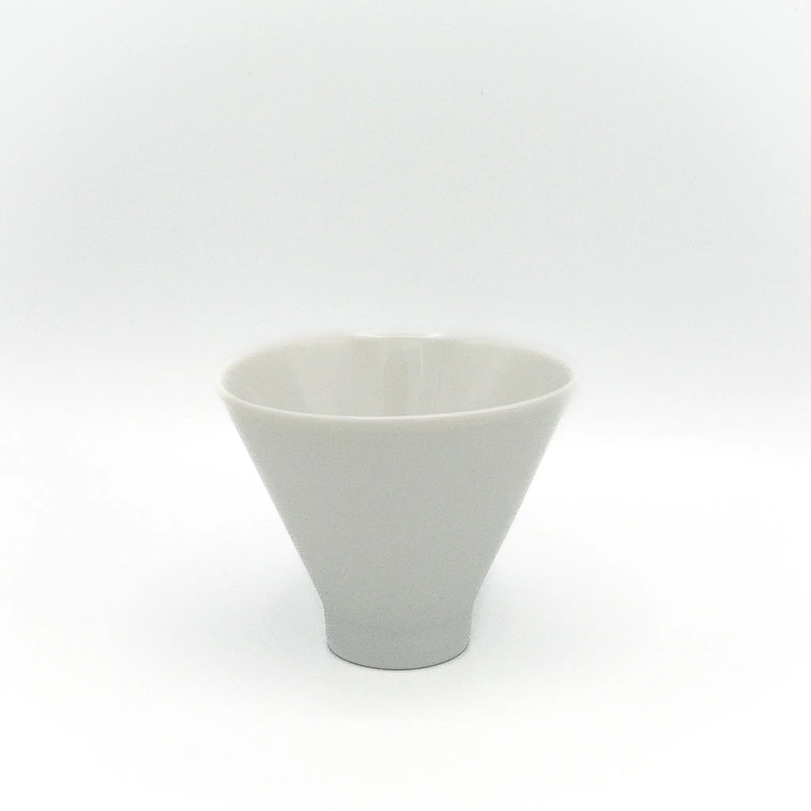 White ceramic cup in an inverted cone shape on a white background