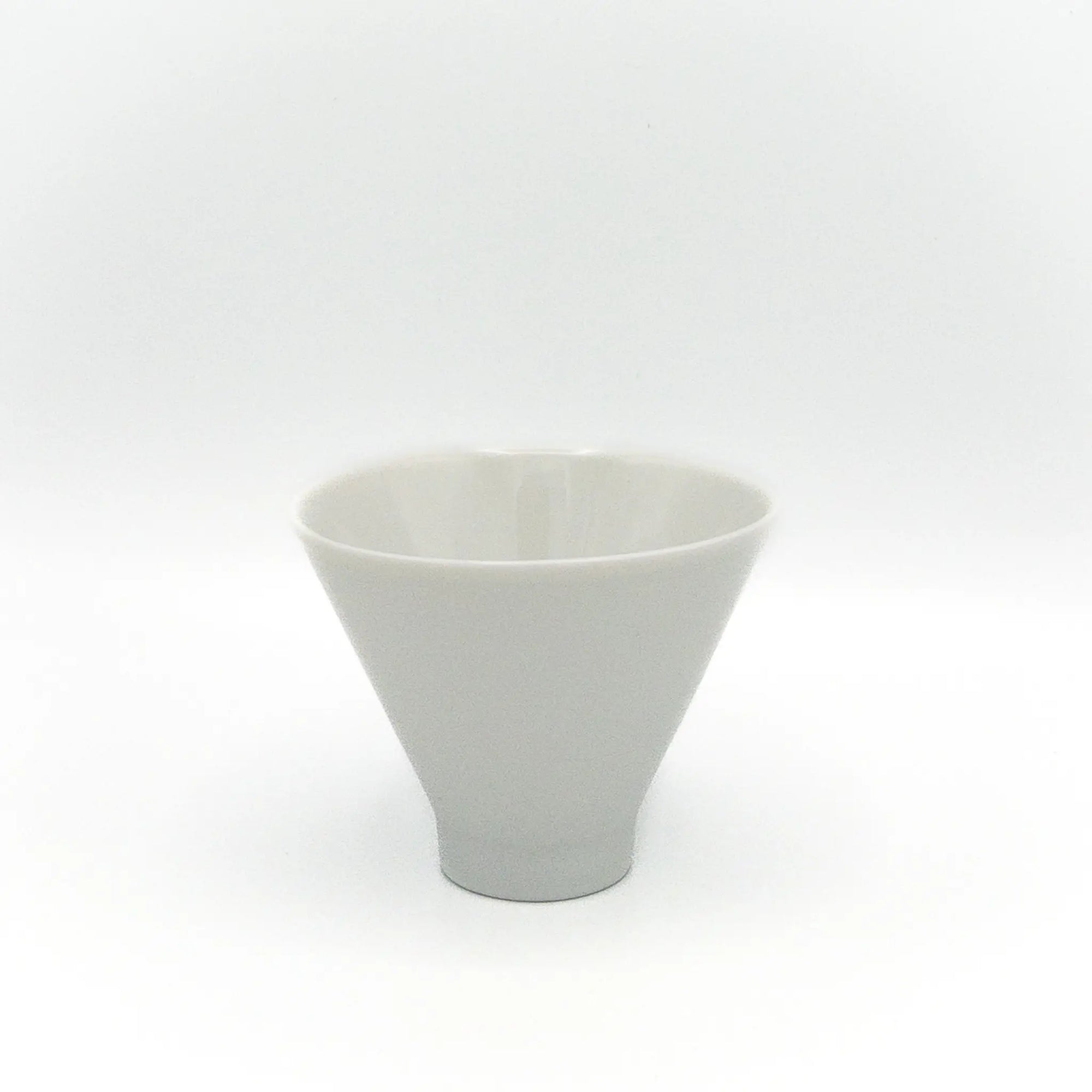 White ceramic cup in an inverted cone shape on a white background
