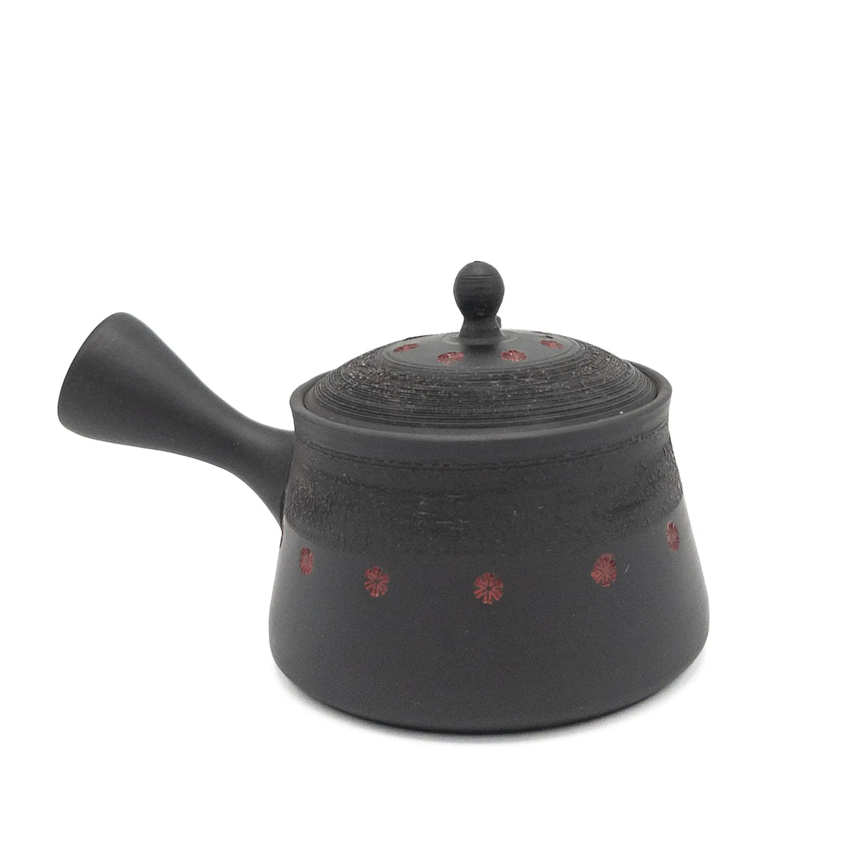 Black teapot with red patterns on a white background