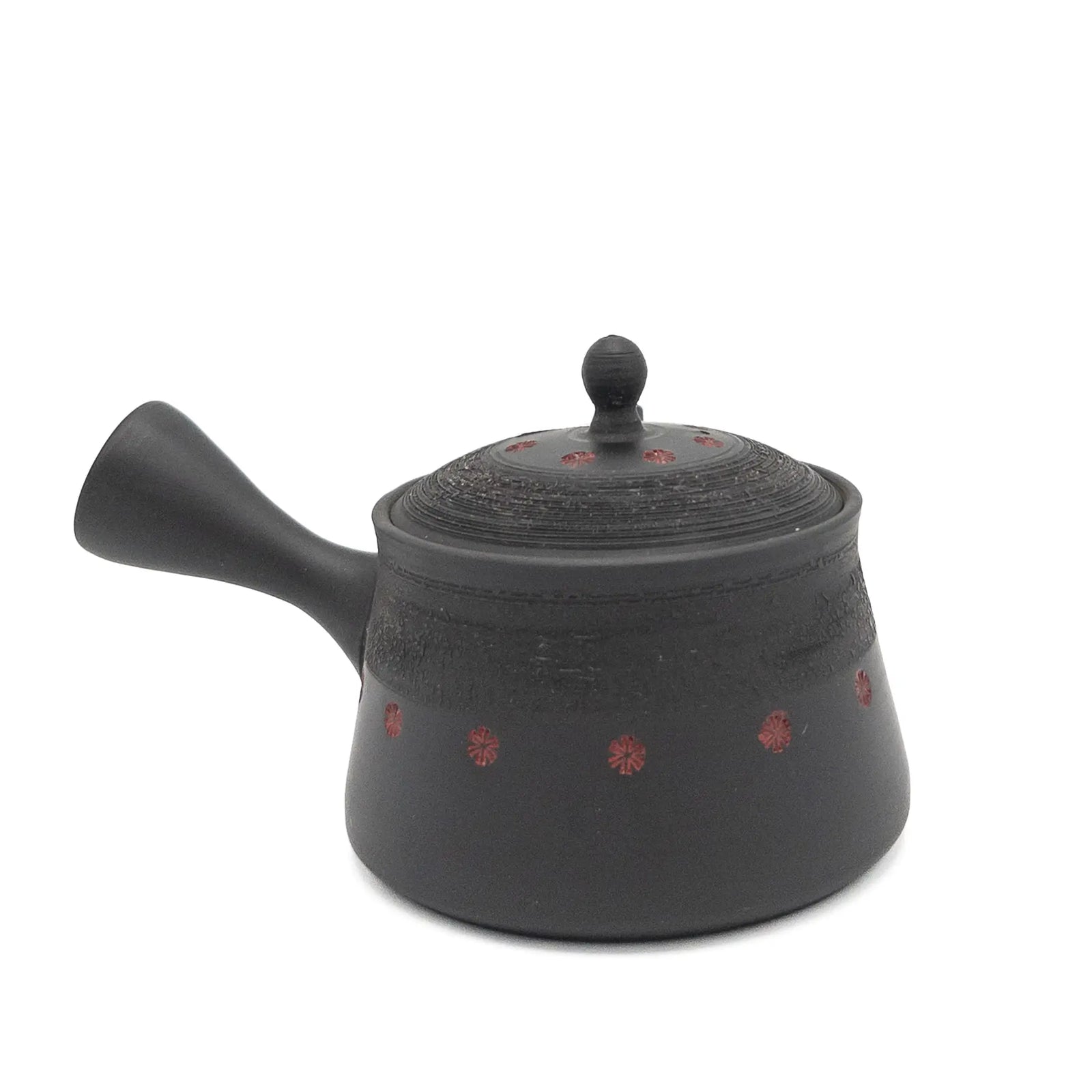 Black teapot with red patterns on a white background