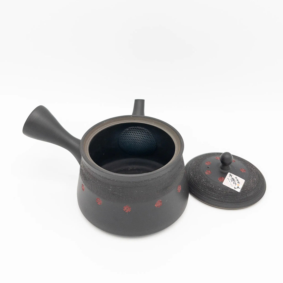 Black ceramic teapot with lid on a white background