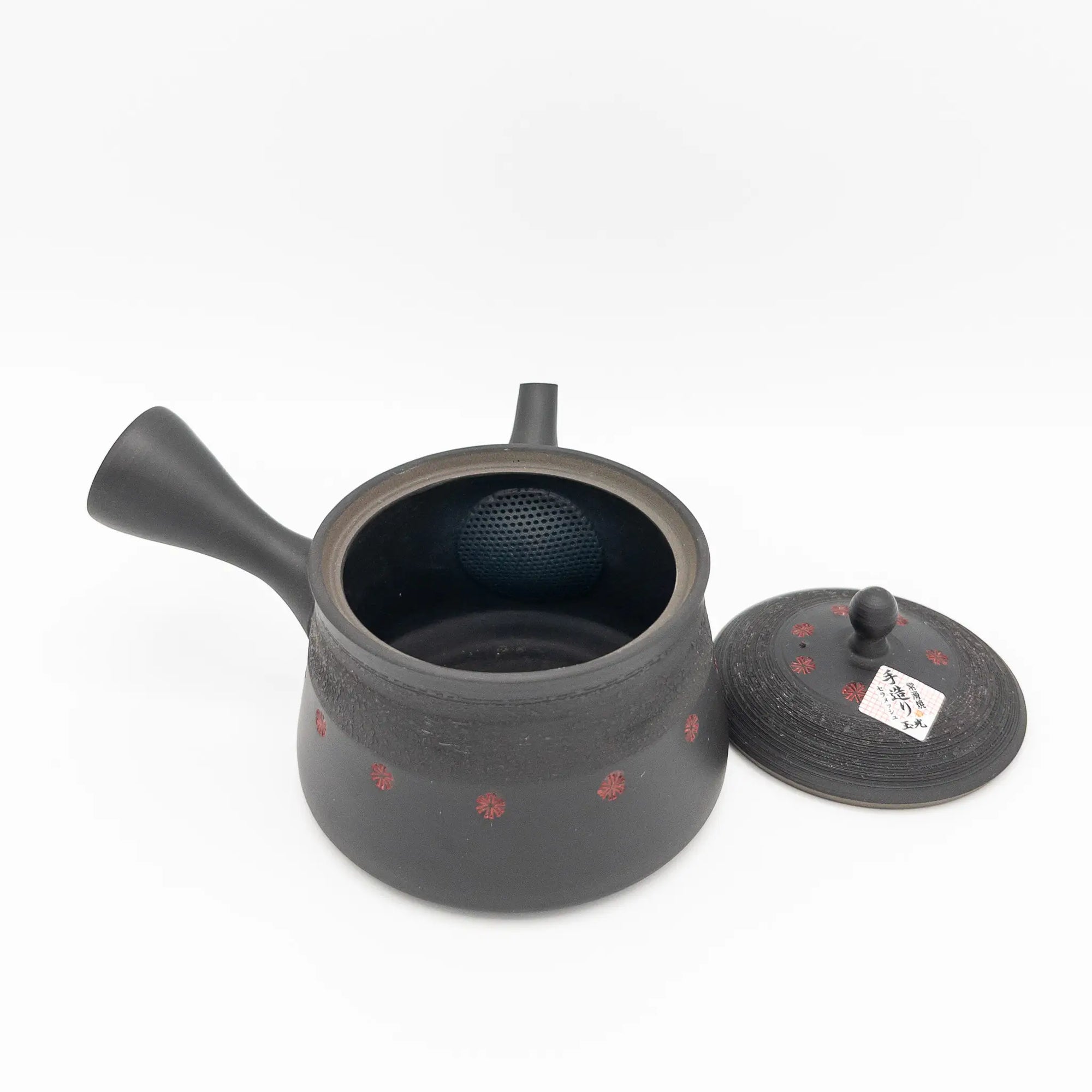 Black ceramic teapot with lid on a white background