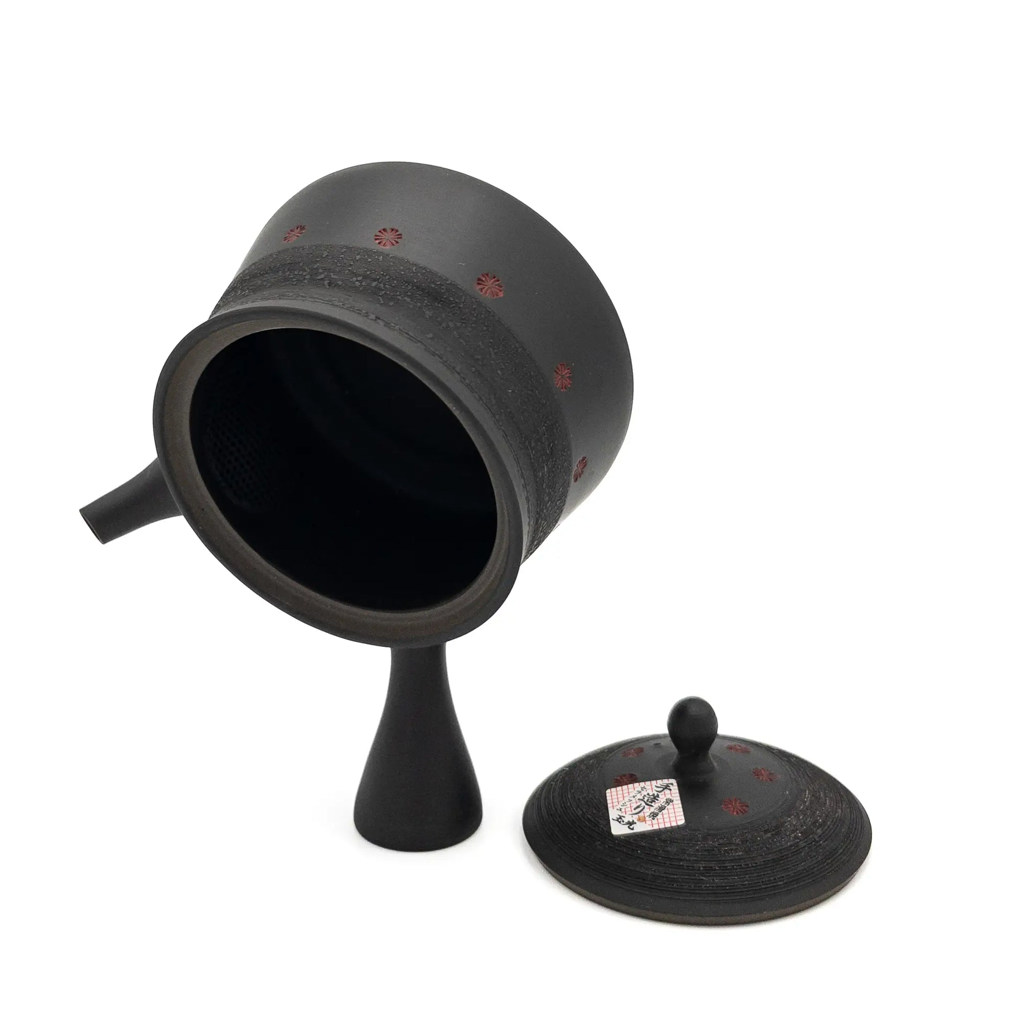 Black ceramic teapot with lid on a white background