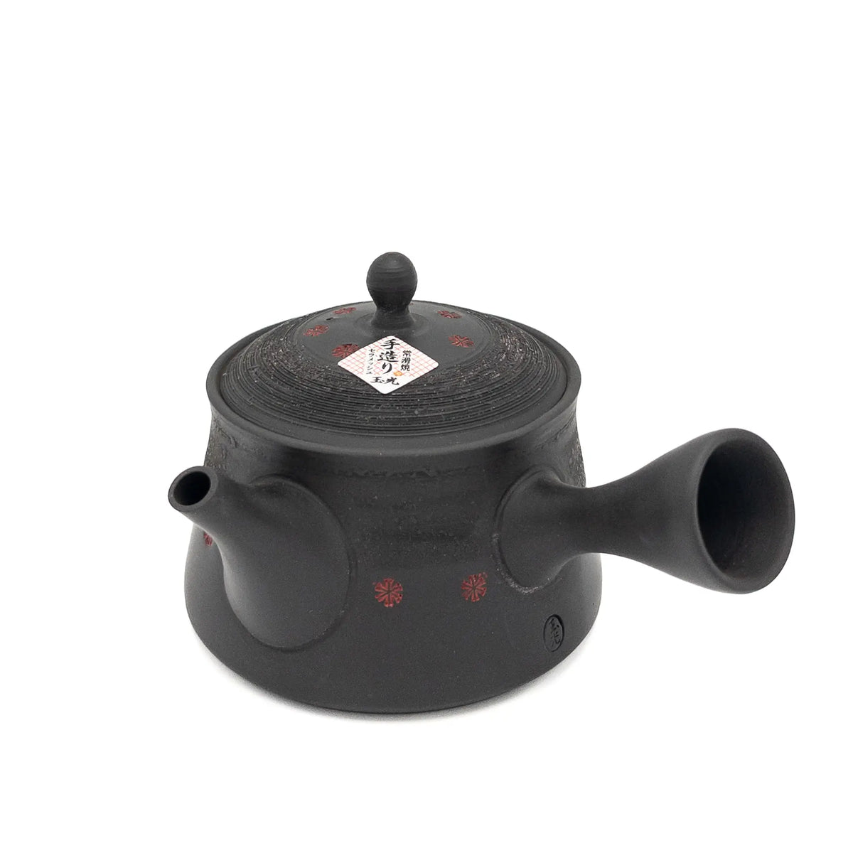 Black teapot with lid on a white background