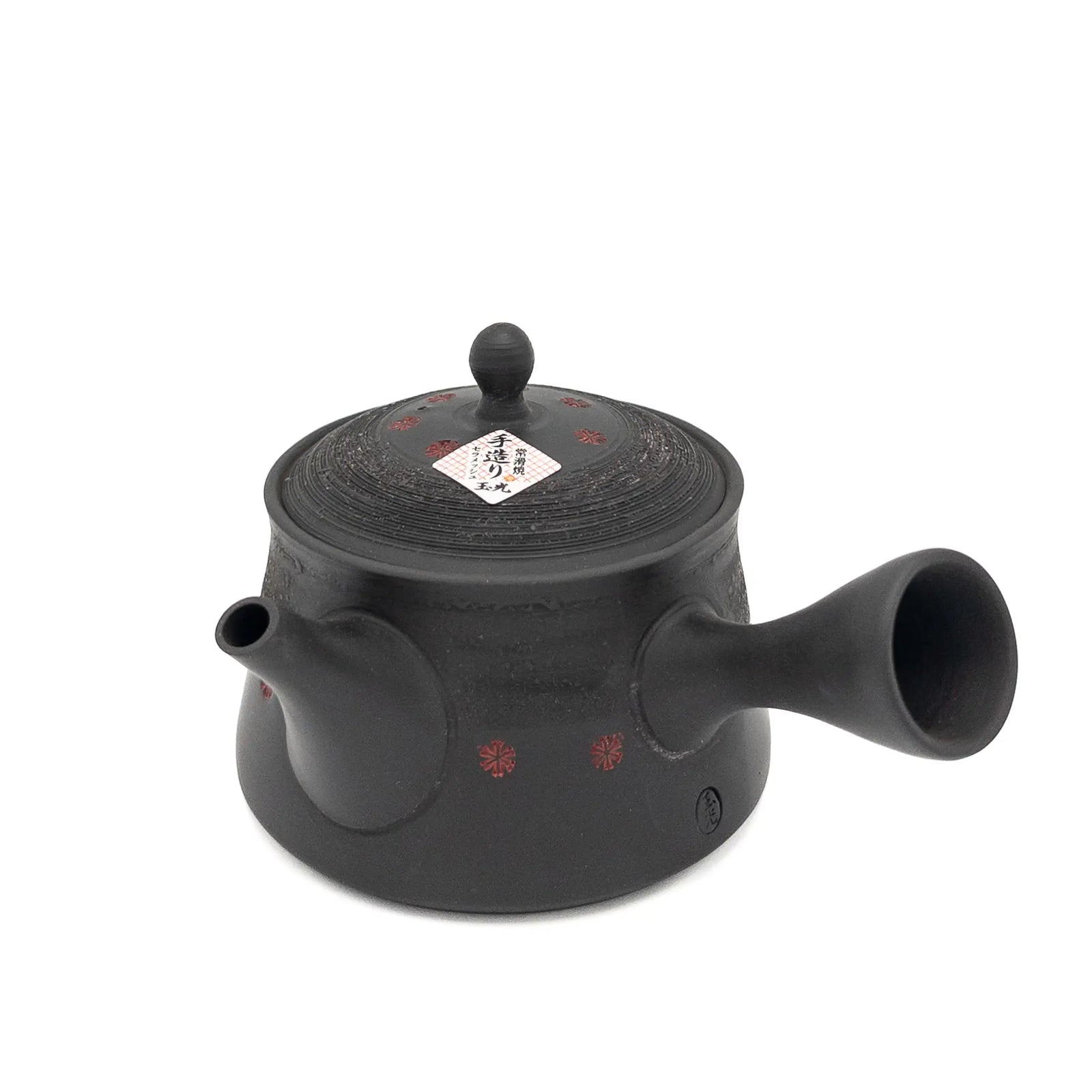 Black teapot with lid on a white background