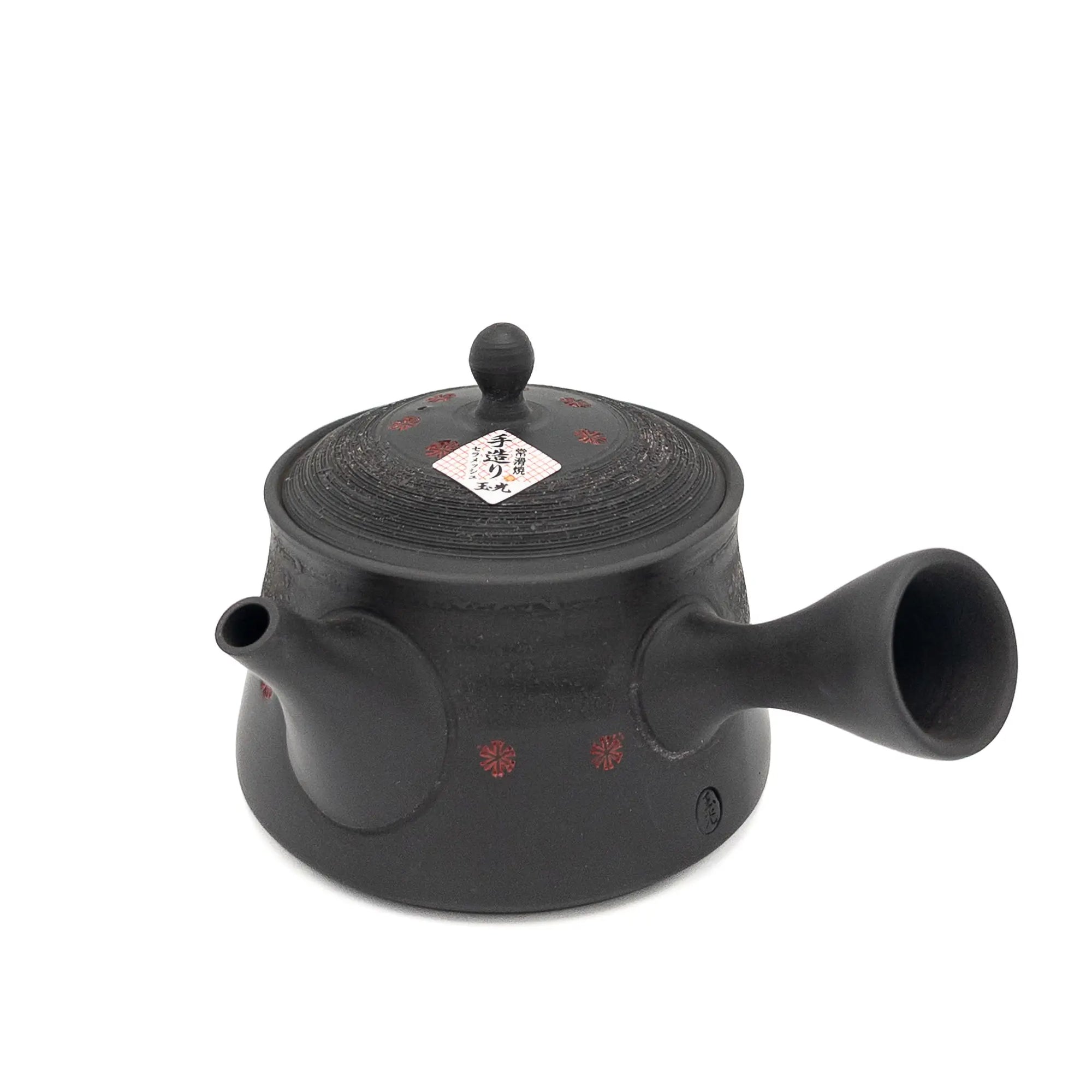 Black teapot with lid on a white background