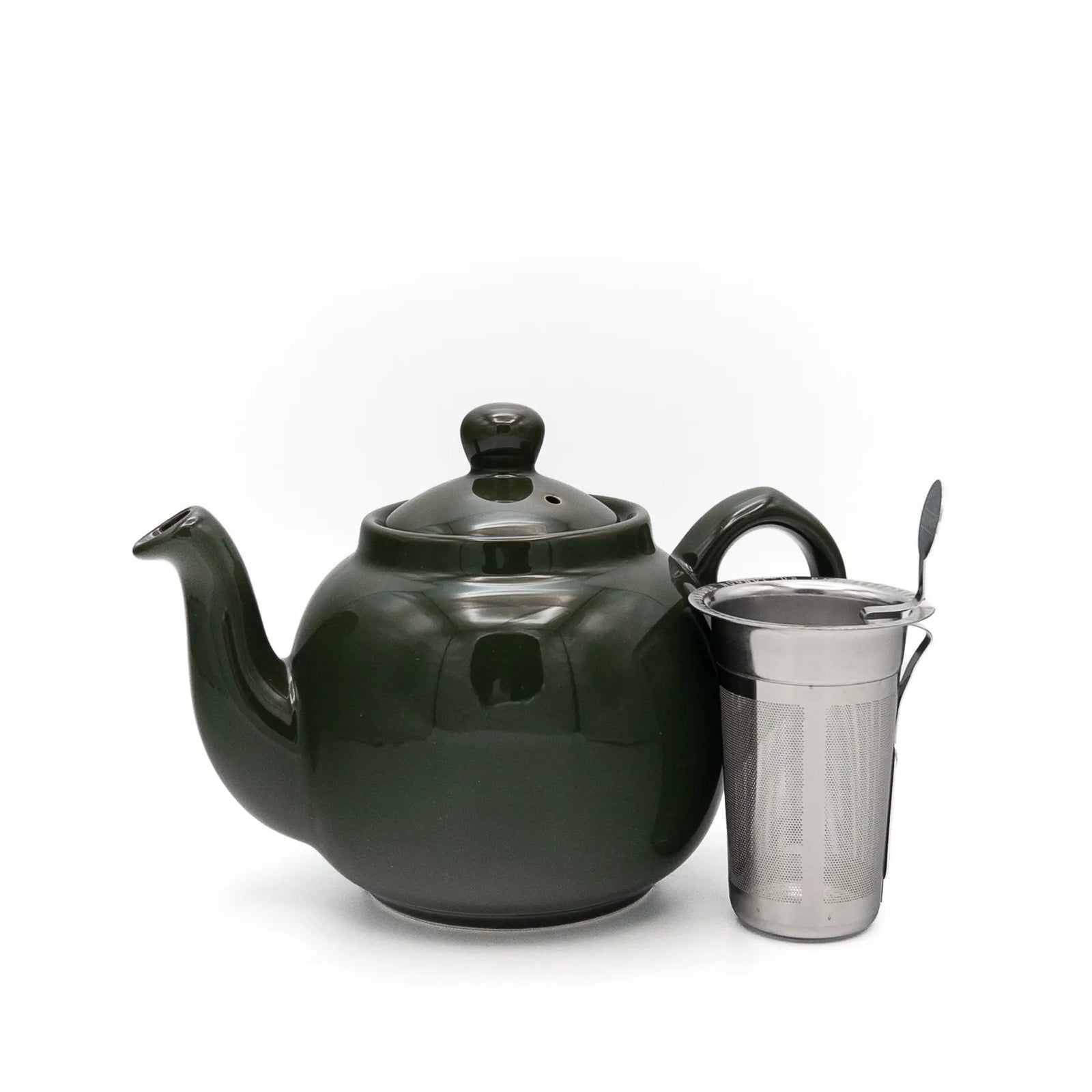 A dark green ceramic teapot with a matching lid, shown next to a stainless steel tea infuser on a clean white background.