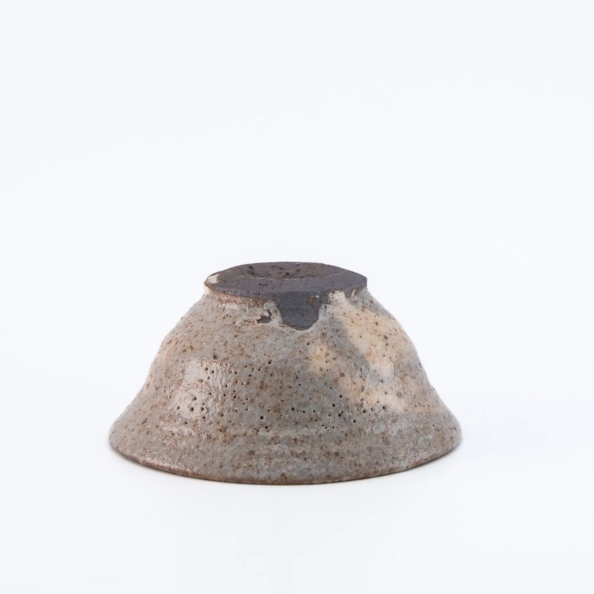 Ceramic cup with speckled texture on a white background
