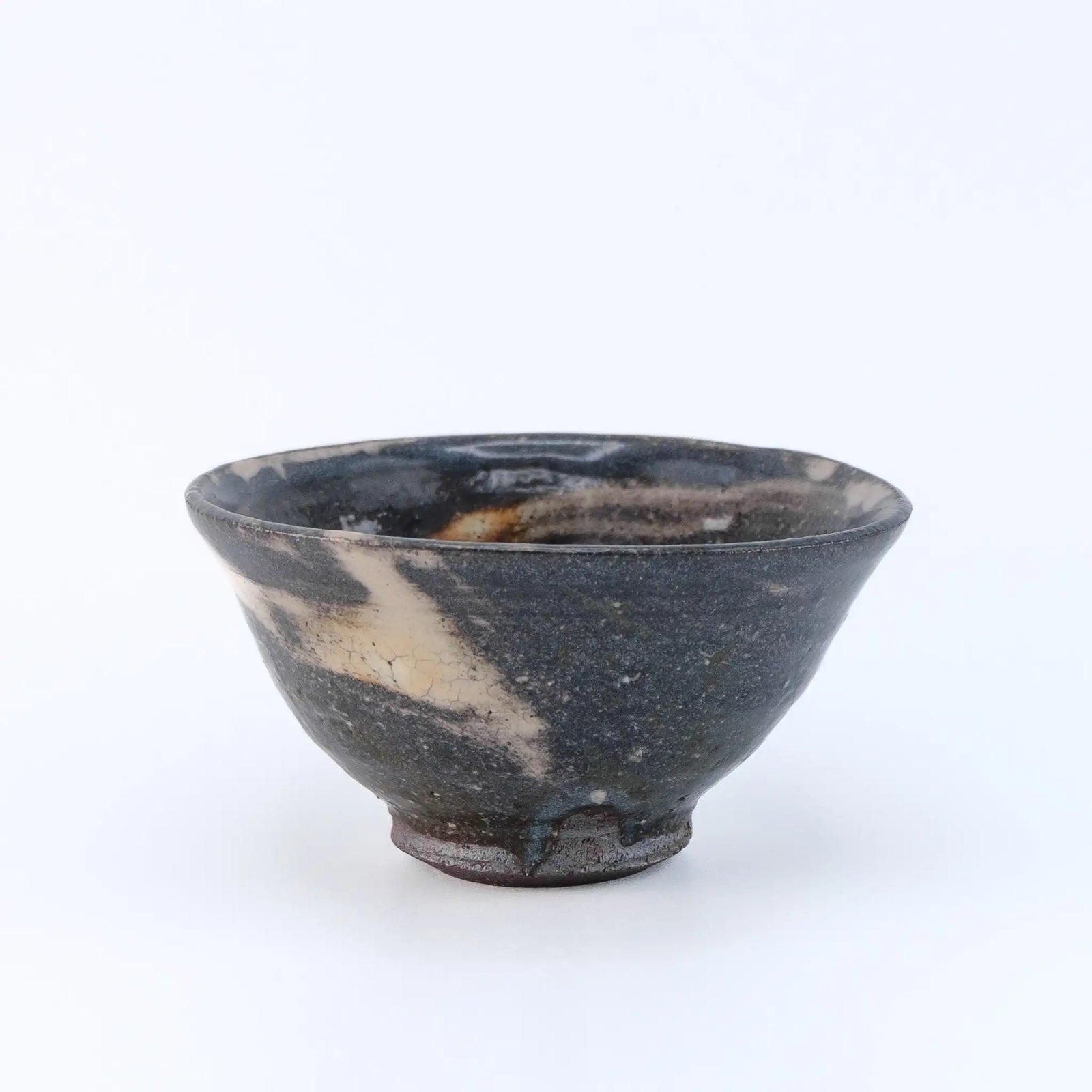Black ceramic cup with marbled design on a white background