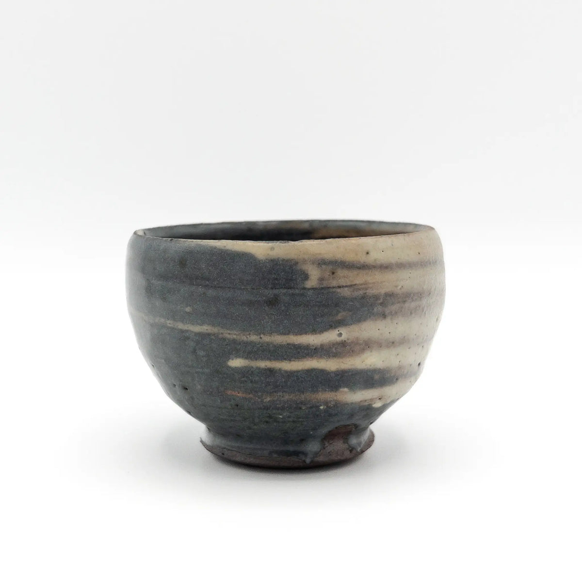 Ceramic cup with a textured surface on a white background