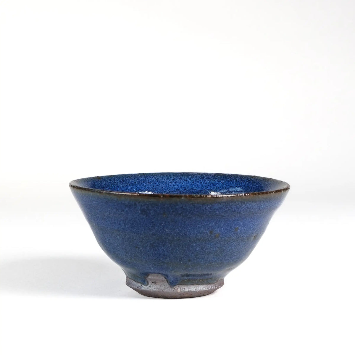Blue-Purple ceramic handmade teacup on a white background