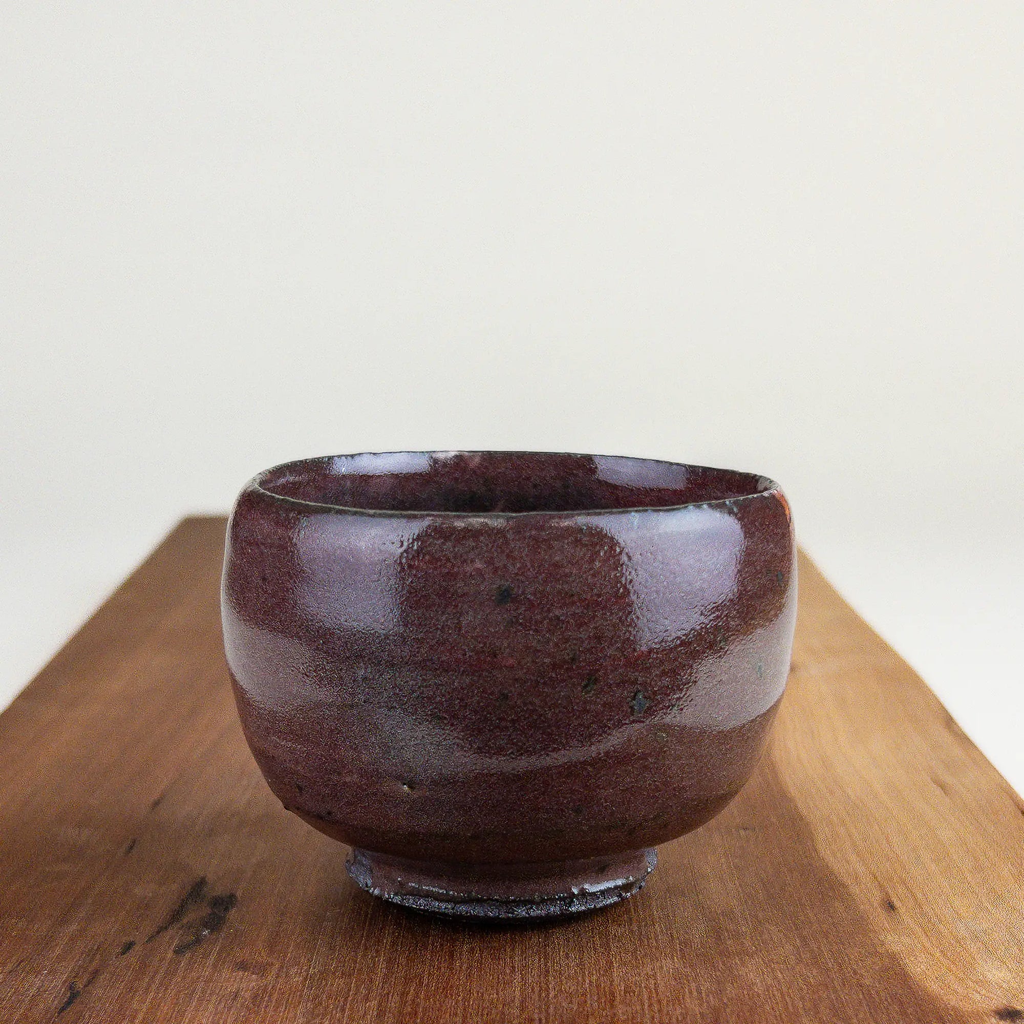 Ceramic cup on a wooden surface with a white background