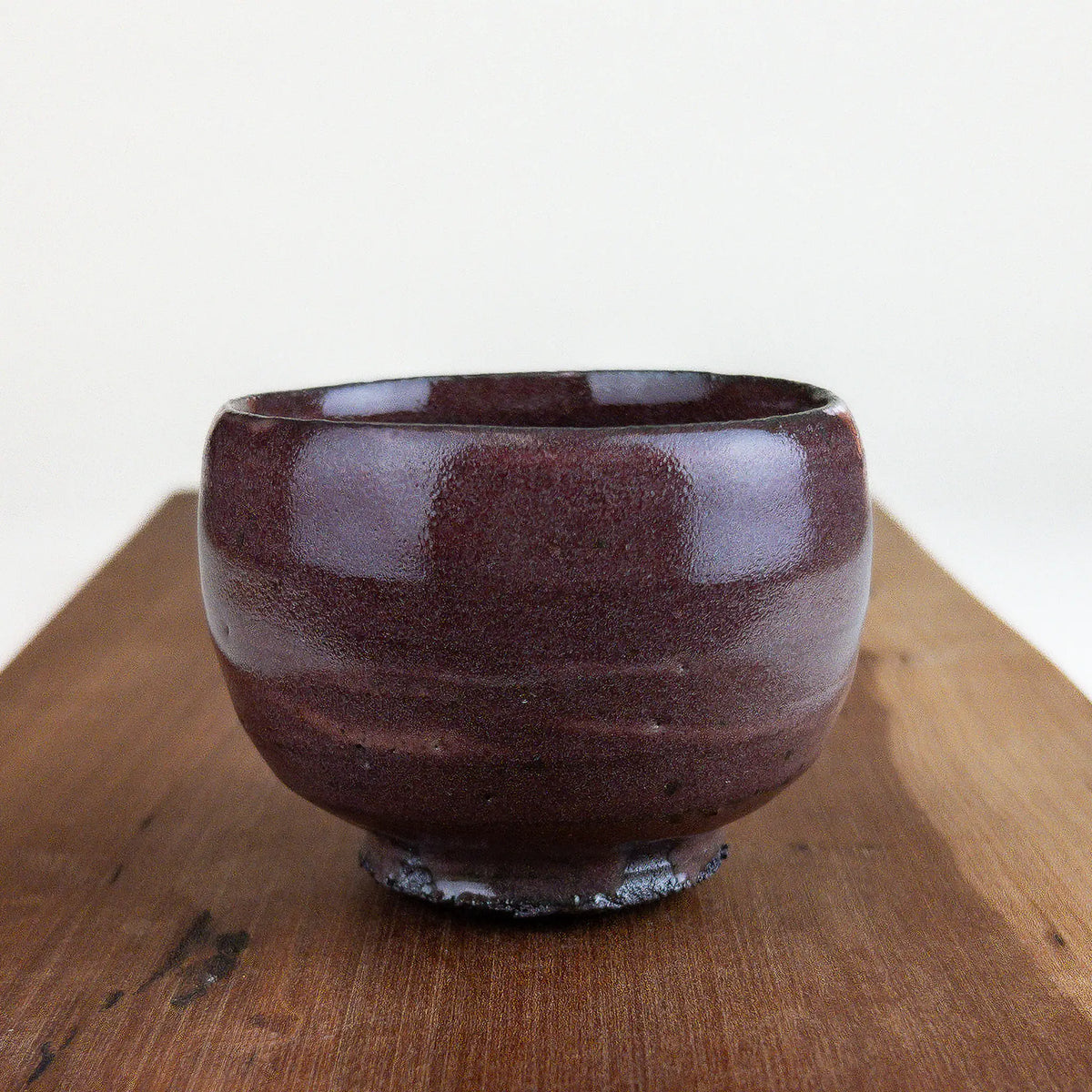 Ceramic cup on a wooden surface with a white background