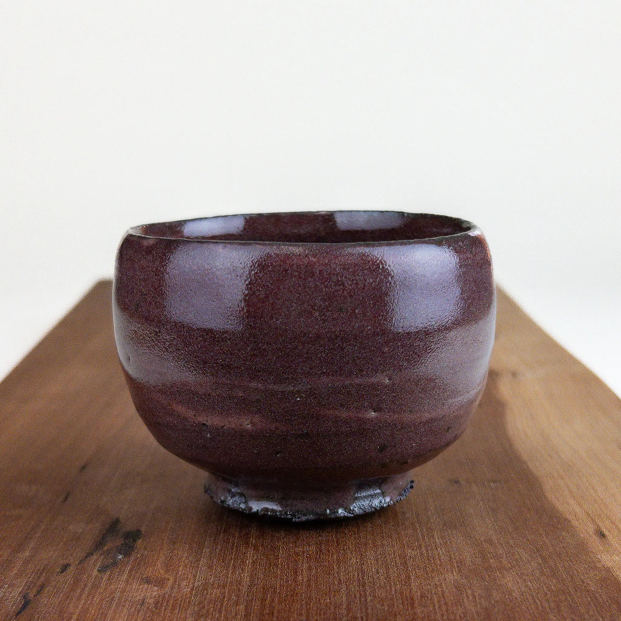 Ceramic cup on a wooden surface with a white background
