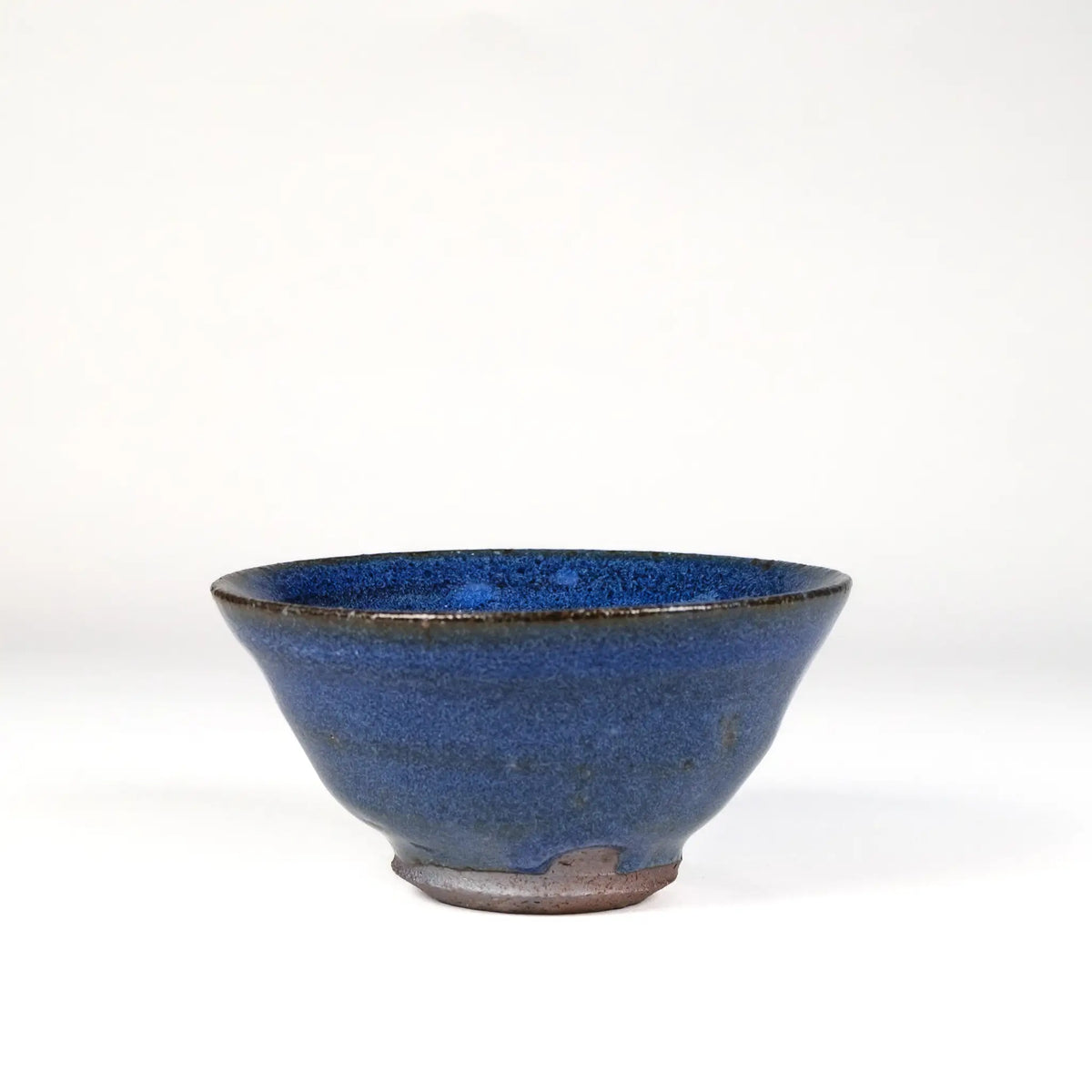 Blue-Purple ceramic handmade teacup on a white background
