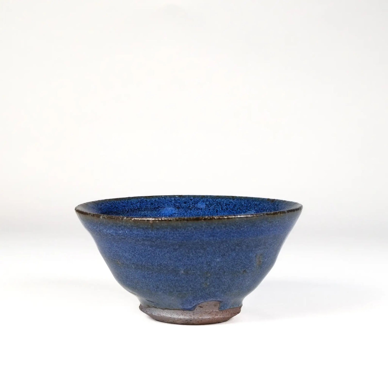 Blue-Purple ceramic handmade teacup on a white background