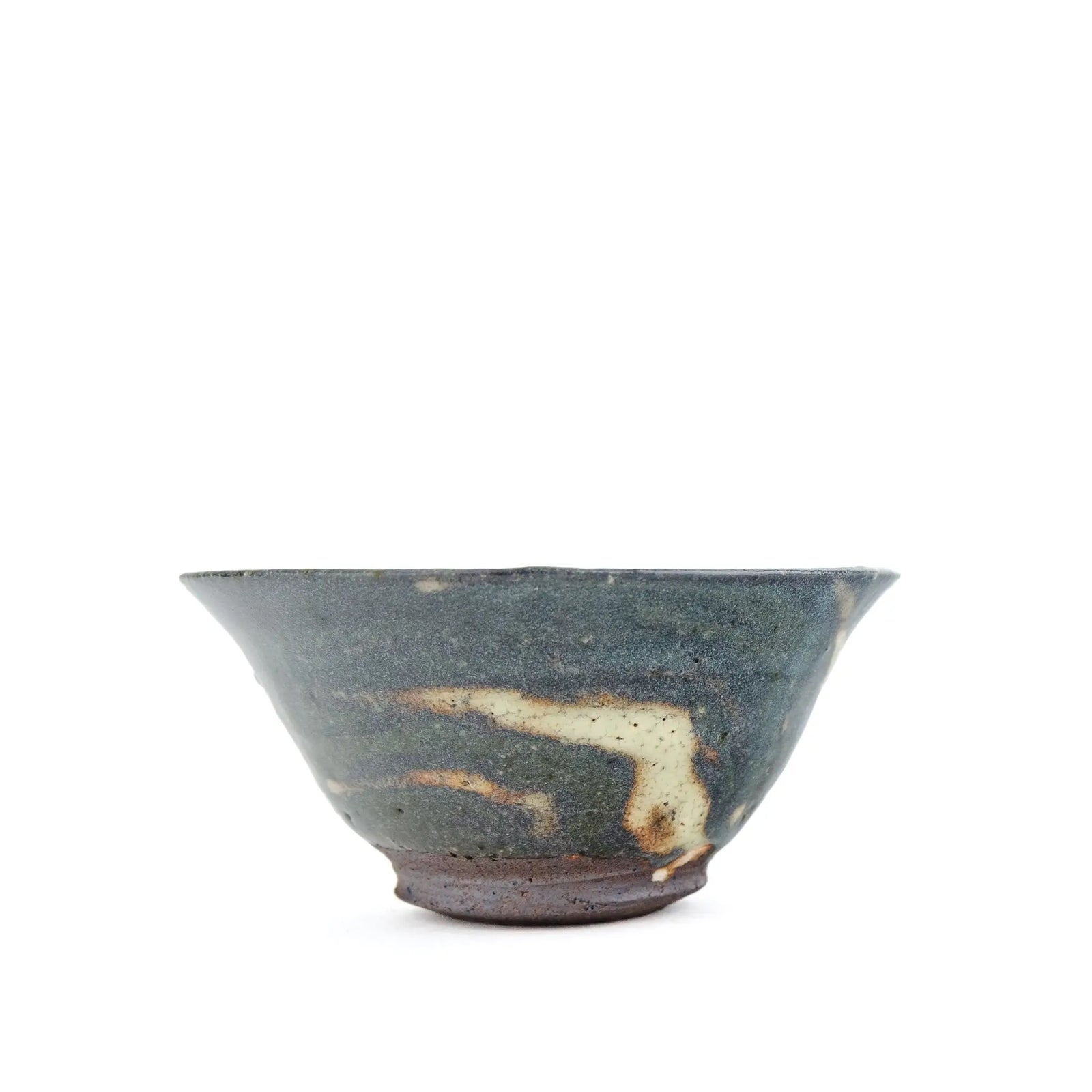 A handmade ceramic teacup with a dark green glaze, featuring natural earthy brown and cream-colored marbling on the exterior, set against a plain white background.