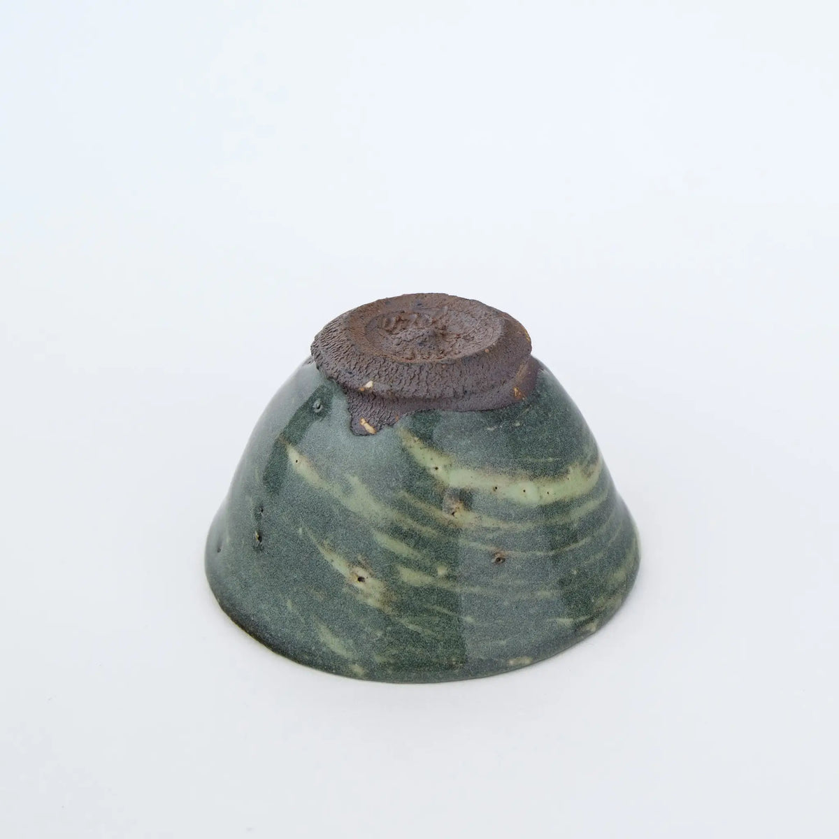 Ceramic teacup on a white background - underside view