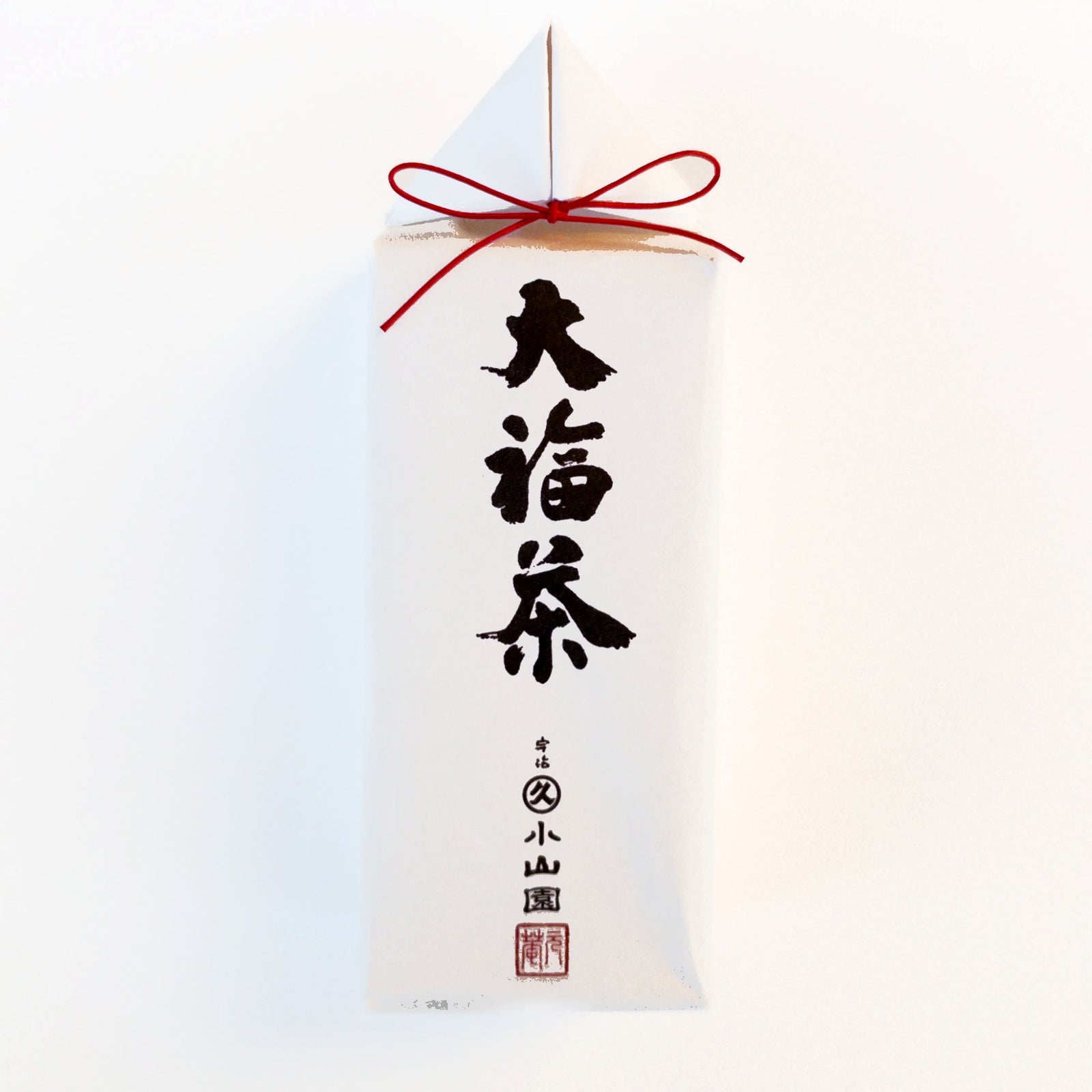 Marukyu Koyamaen Obuku Sencha in traditional Japanese packaging. White washi paper with bold black calligraphy reading "Daifukucha" (Good Fortune Tea), topped with a red mizuhiki cord tied in a decorative bow. The Marukyu Koyamaen maker's mark appears in red at the bottom.