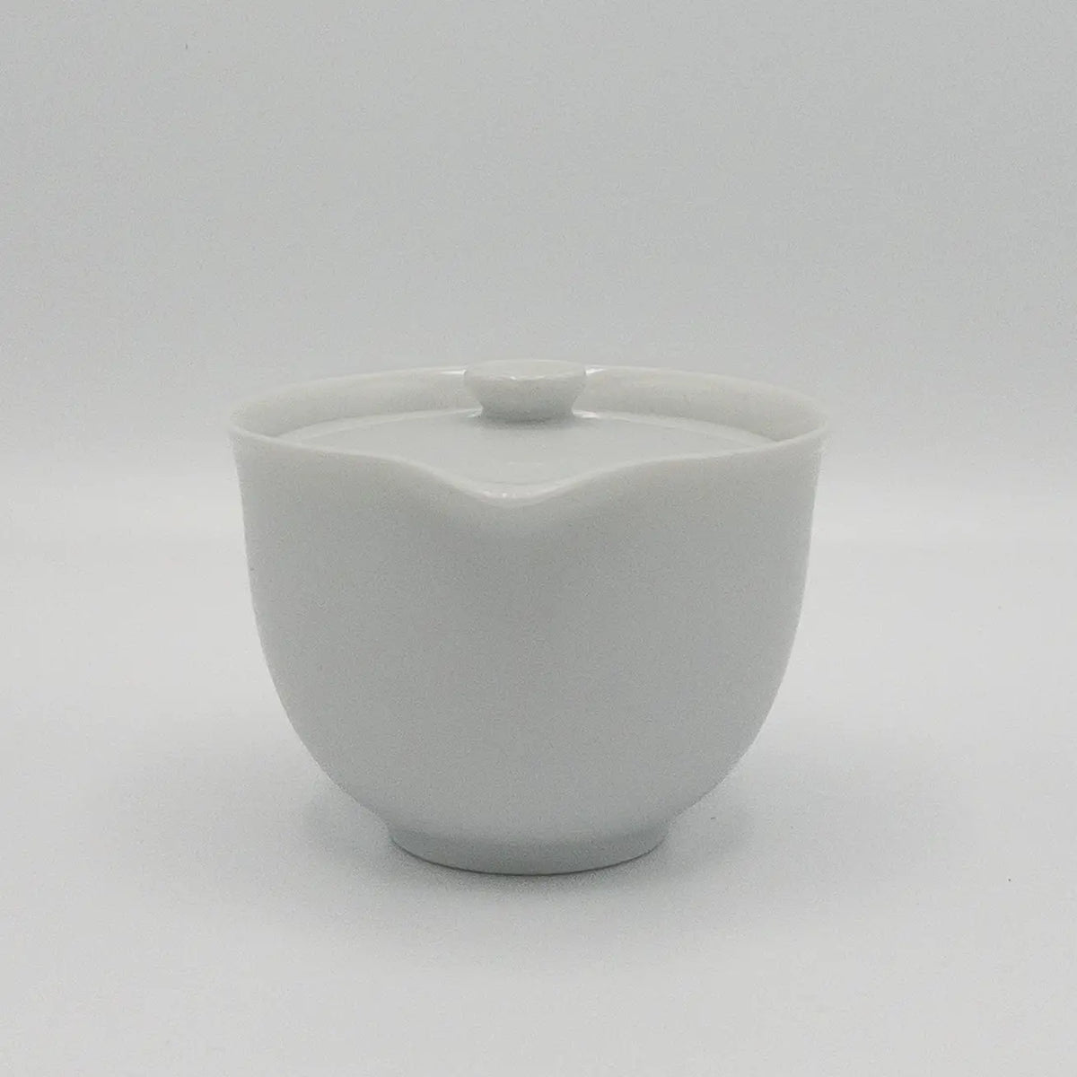White ceramic hohin teapot with lid on a white background
