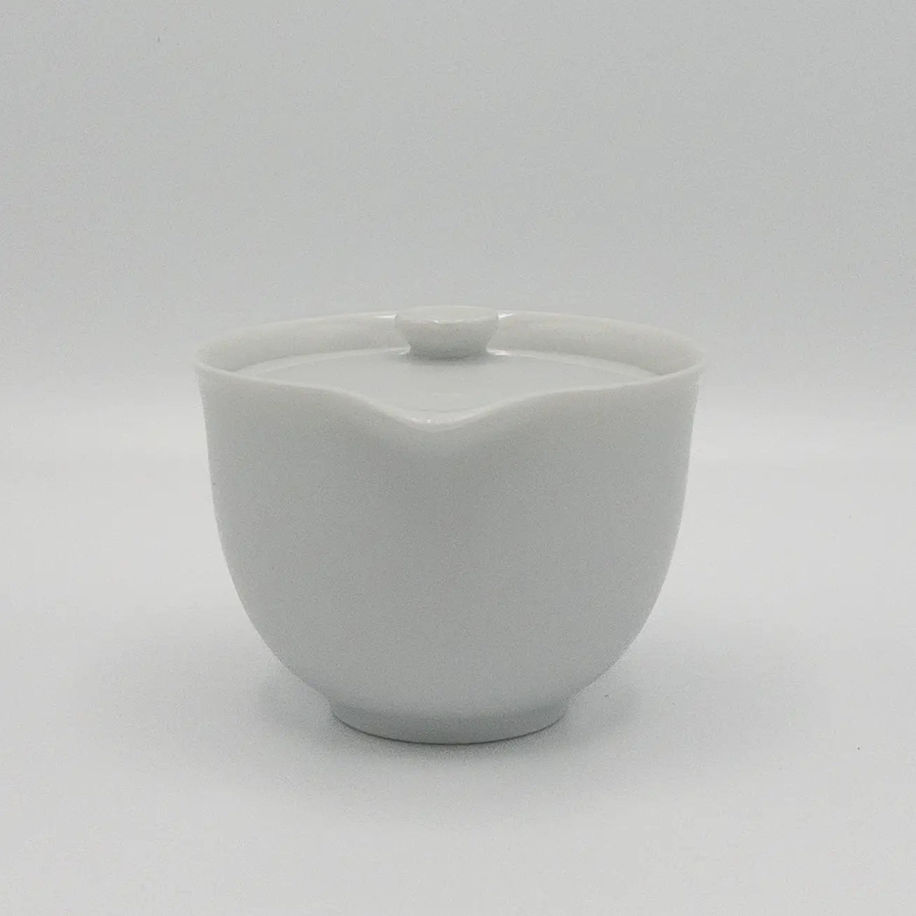 White ceramic hohin teapot with lid on a white background
