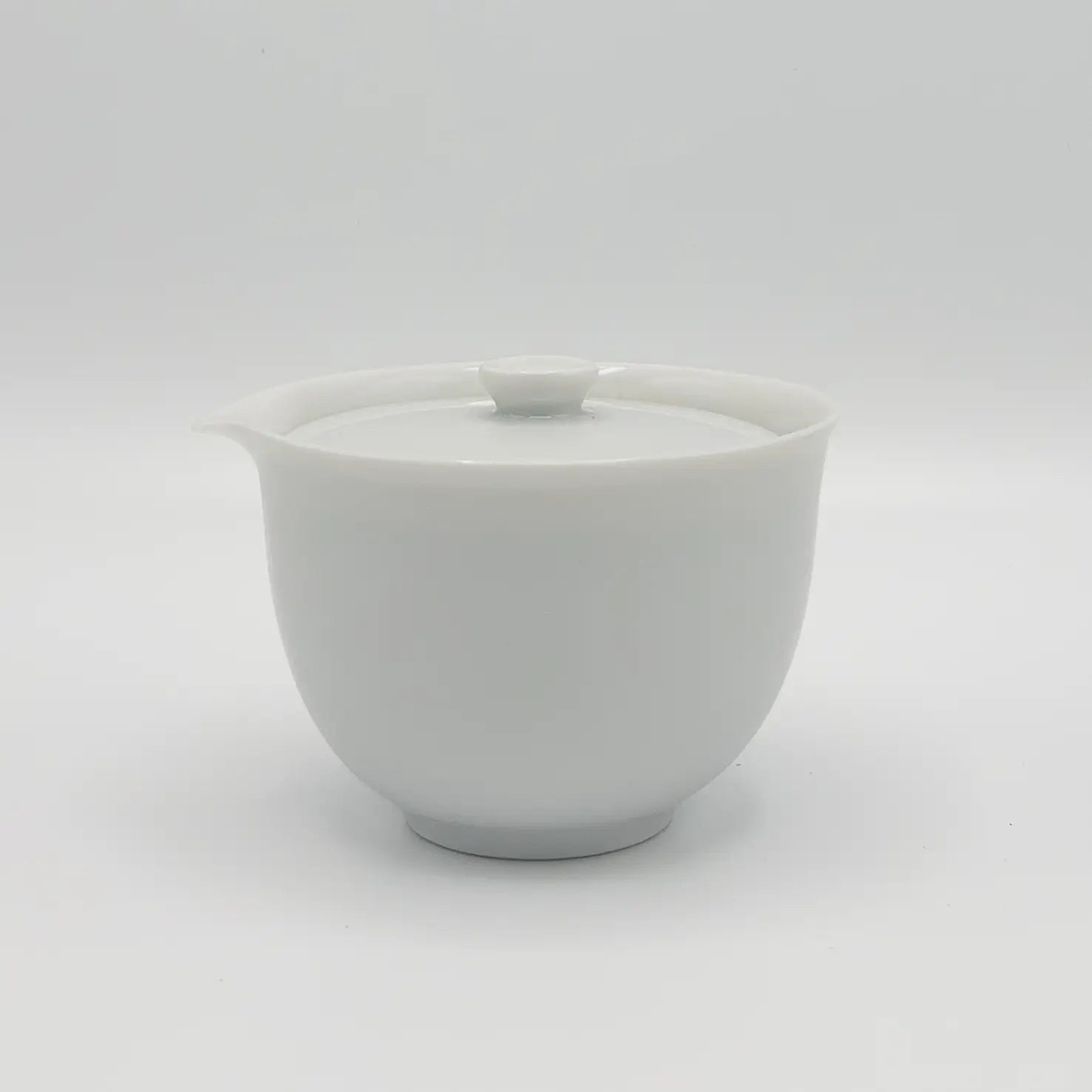 White ceramic hohin teapot with lid on a white background