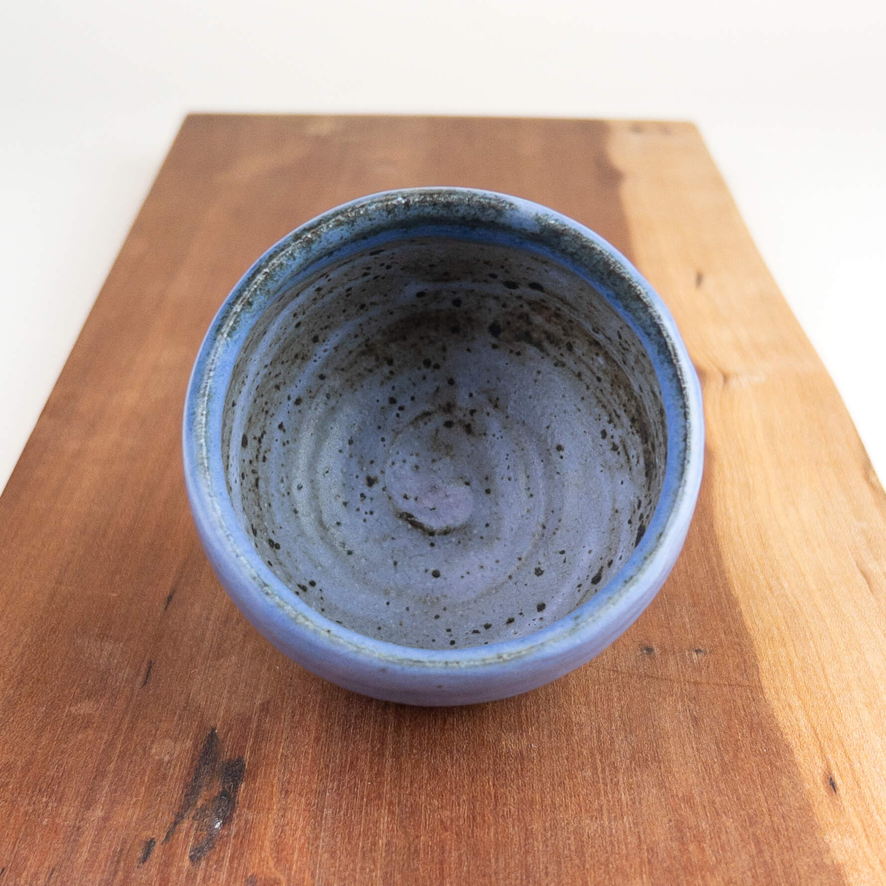 Blue ceramic bowl on a wooden surface