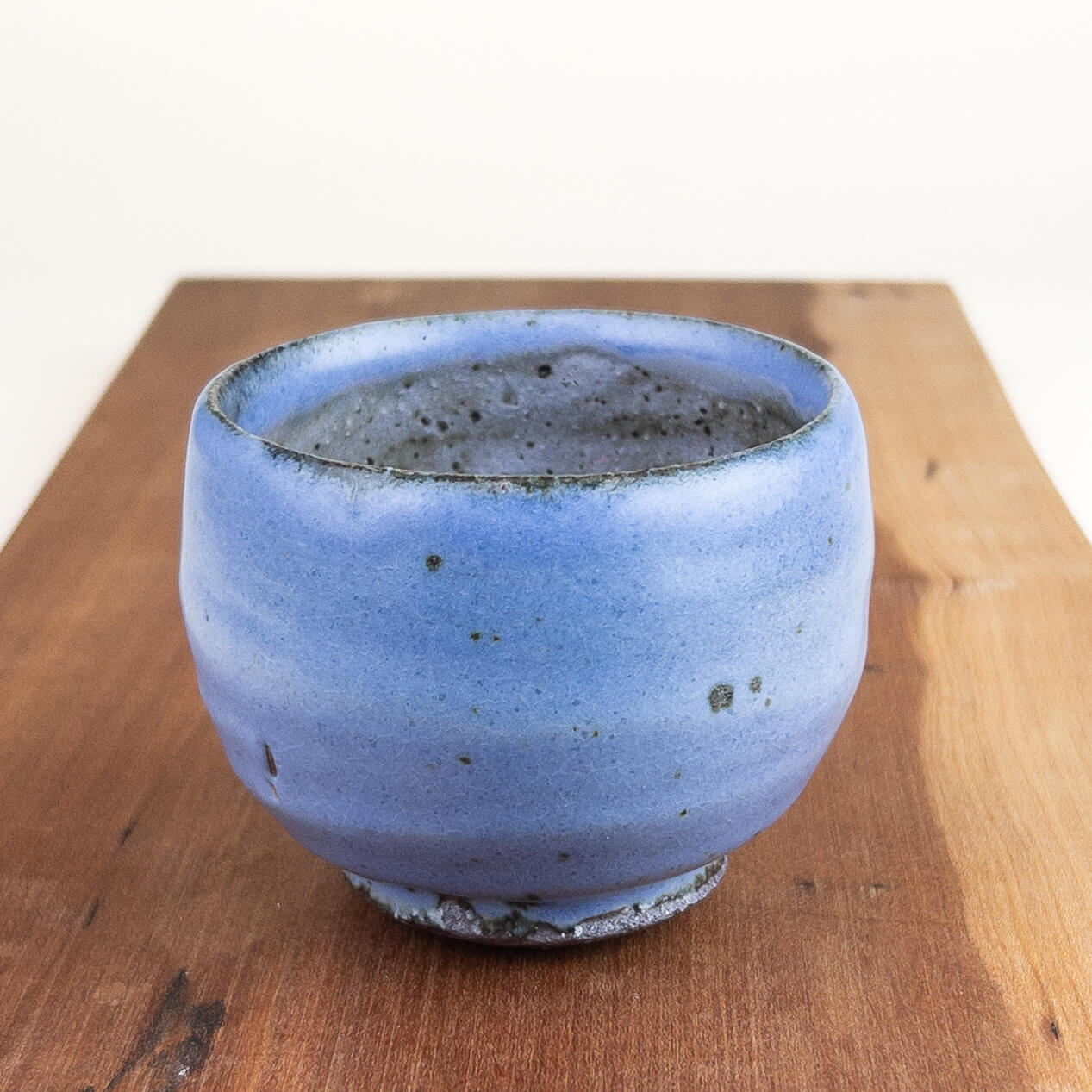 Blue ceramic cup on a wooden surface