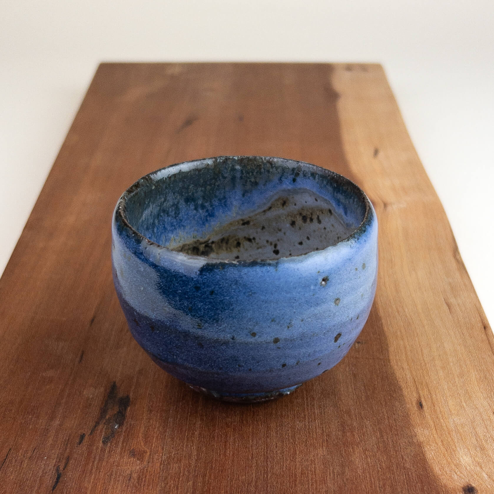 Blue ceramic cup on a wooden surface