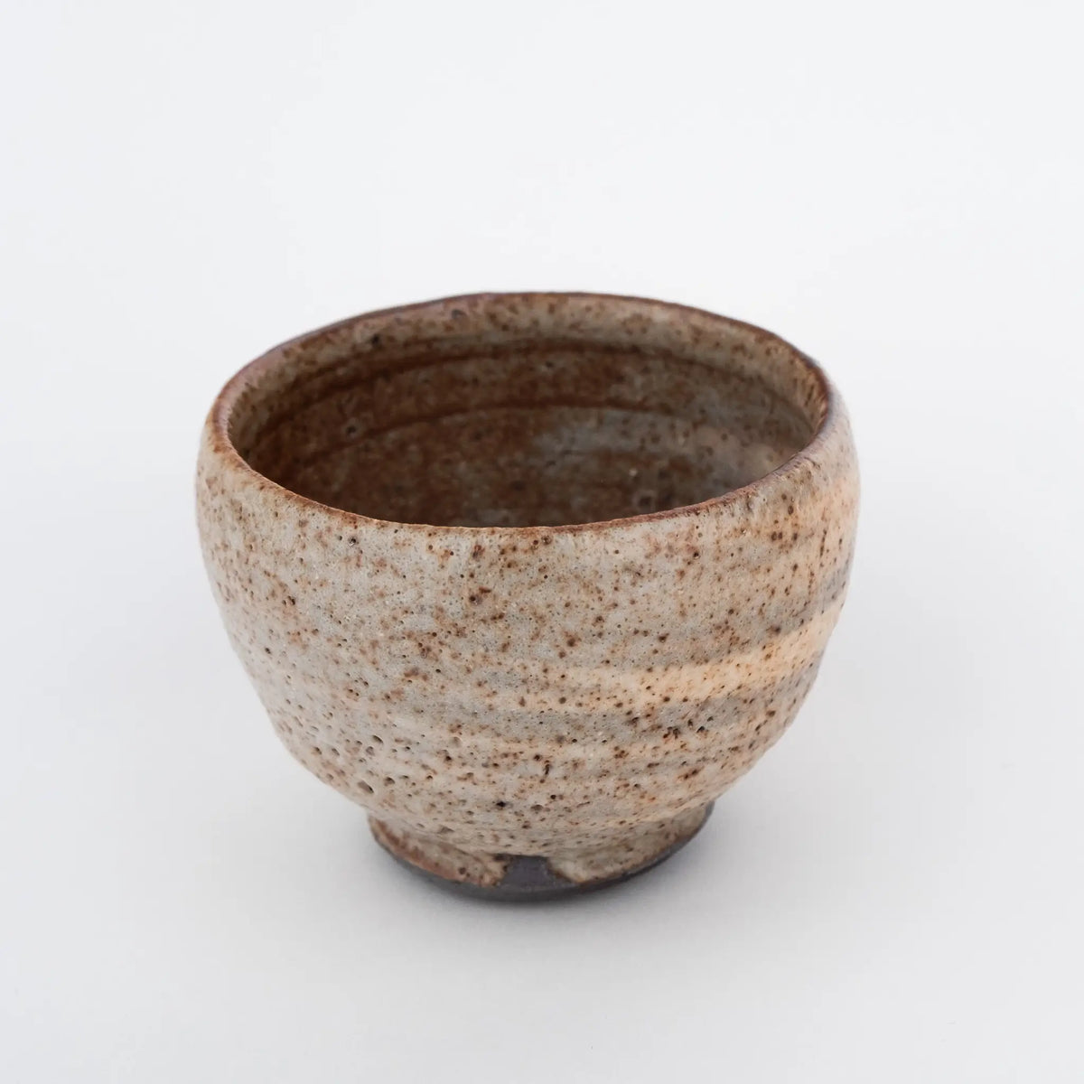 Ceramic tea cup with nice glaze on a white background - an inside view.