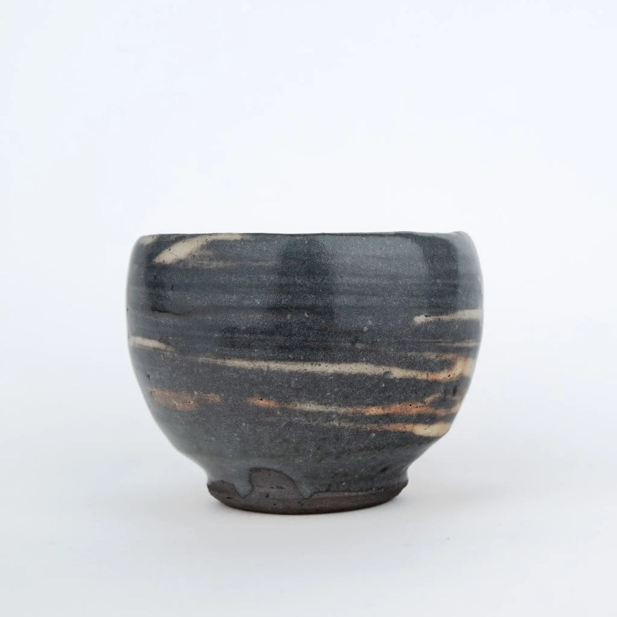Grey handmade tea cup without a handle and with a white streaky glaze
