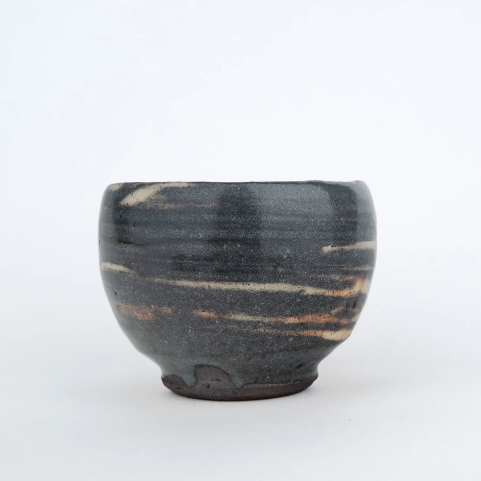 Grey handmade tea cup without a handle and with a white streaky glaze