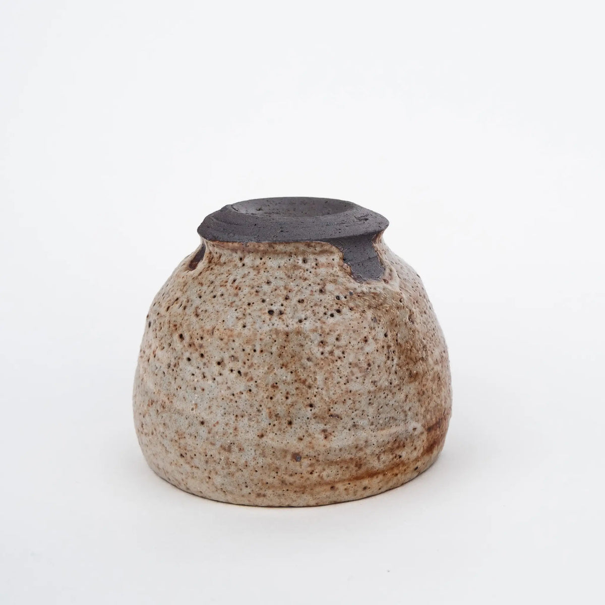Ceramic tea cup with nice glaze on a white background - underside view