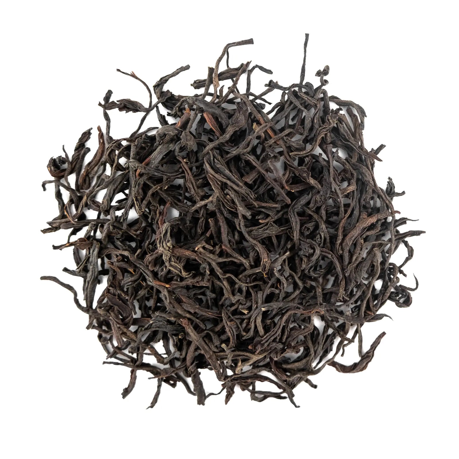 Loose leaf Nokhroy Assam first flush black tea dry tea leaves on a white background.
