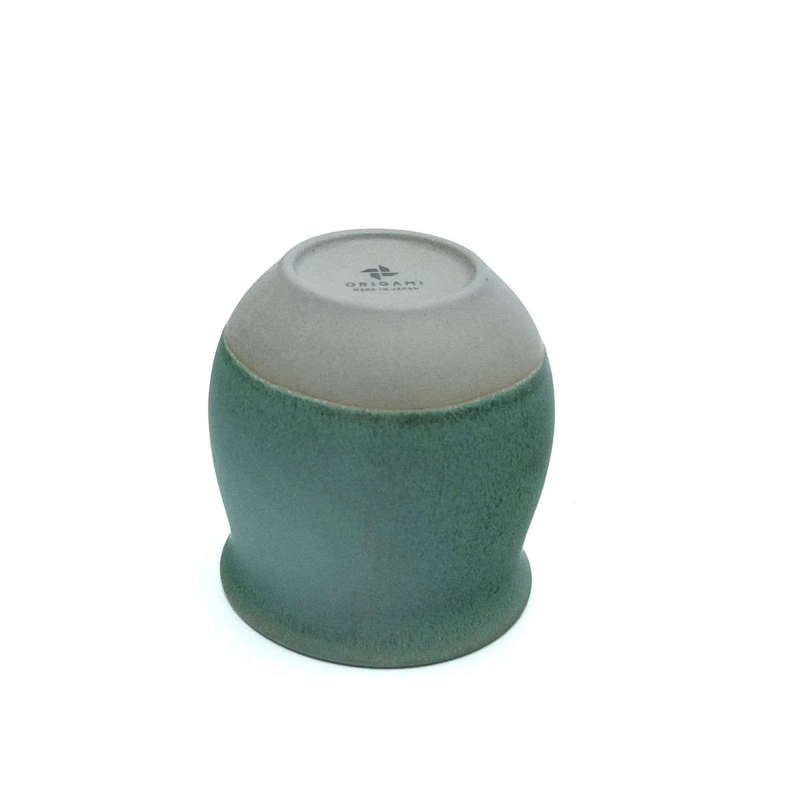 Underside of the green Origami cup showing the unglazed base and the Origami maker's stamp