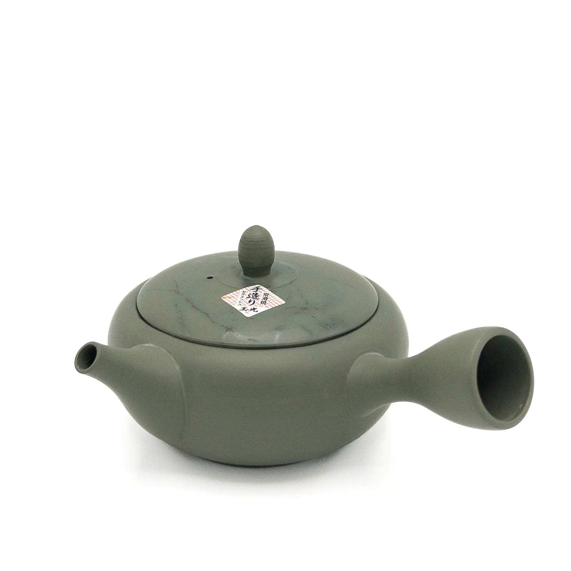 Green ceramic teapot on a white background