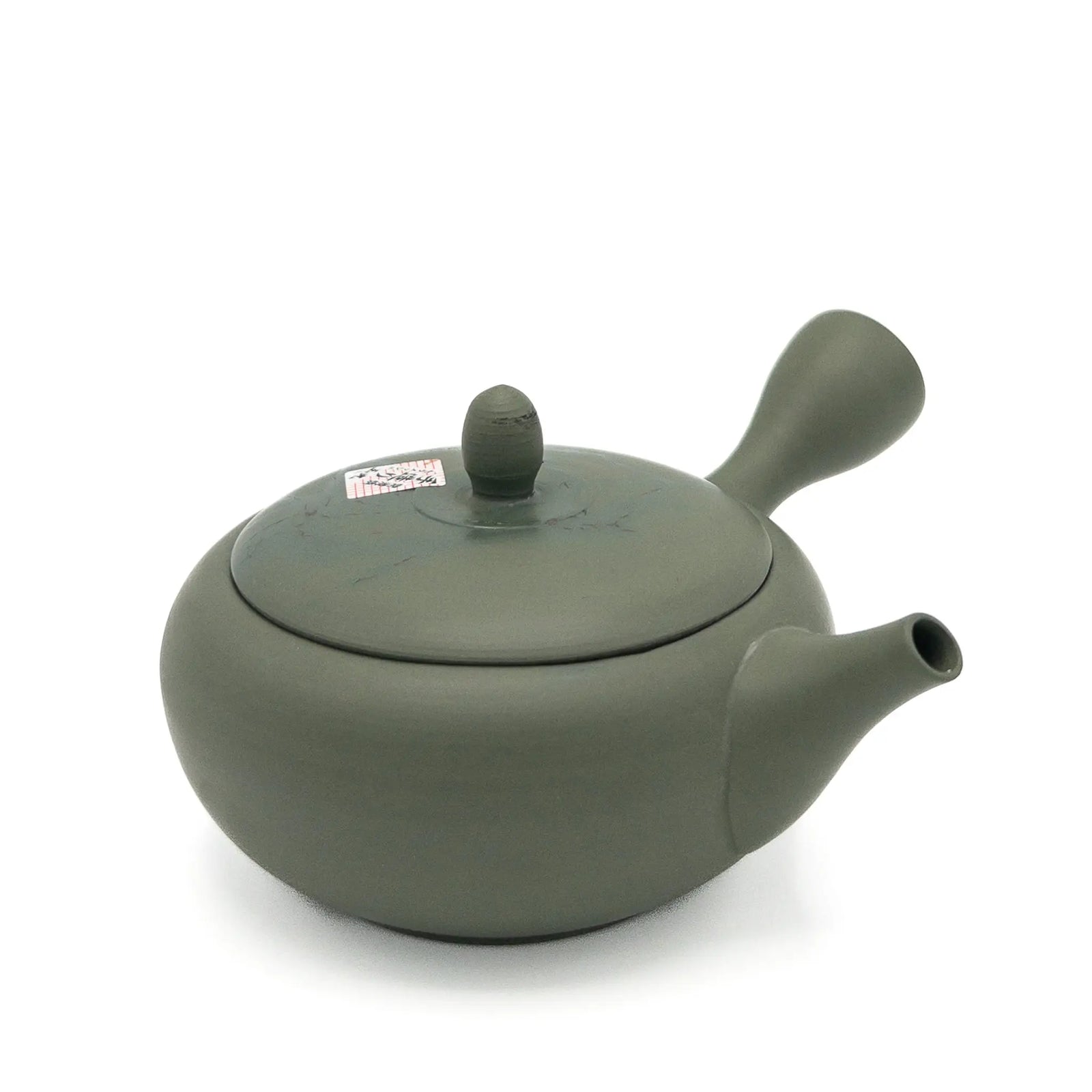 Green ceramic teapot on a white background