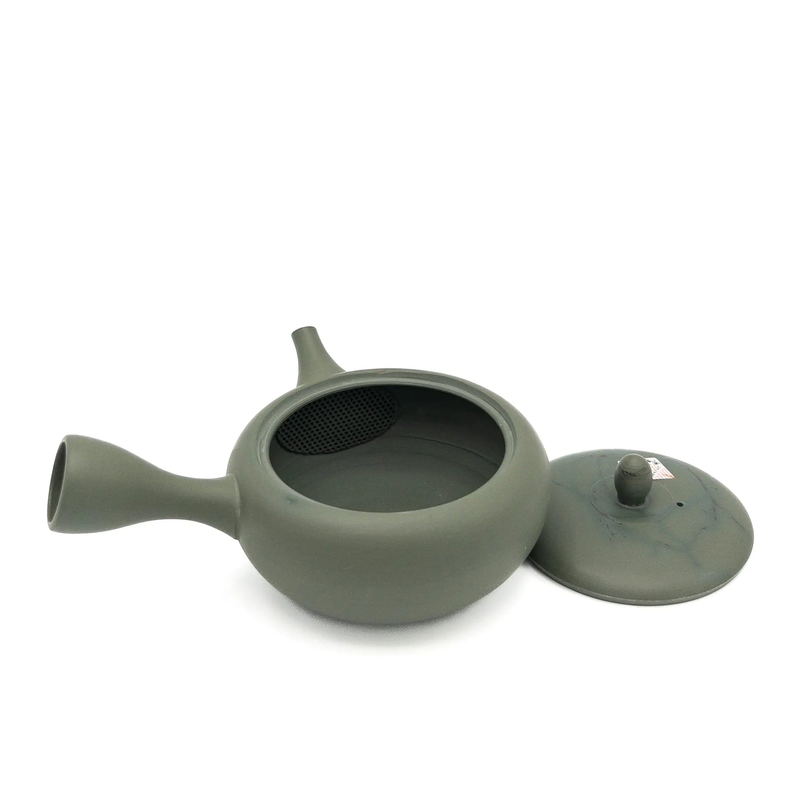 Green ceramic teapot with lid on a white background