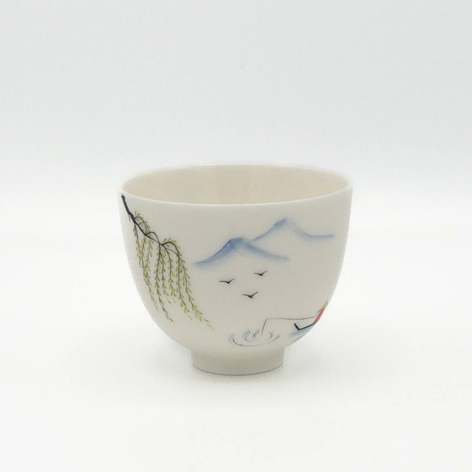 Ceramic cup with artistic designs on a white background