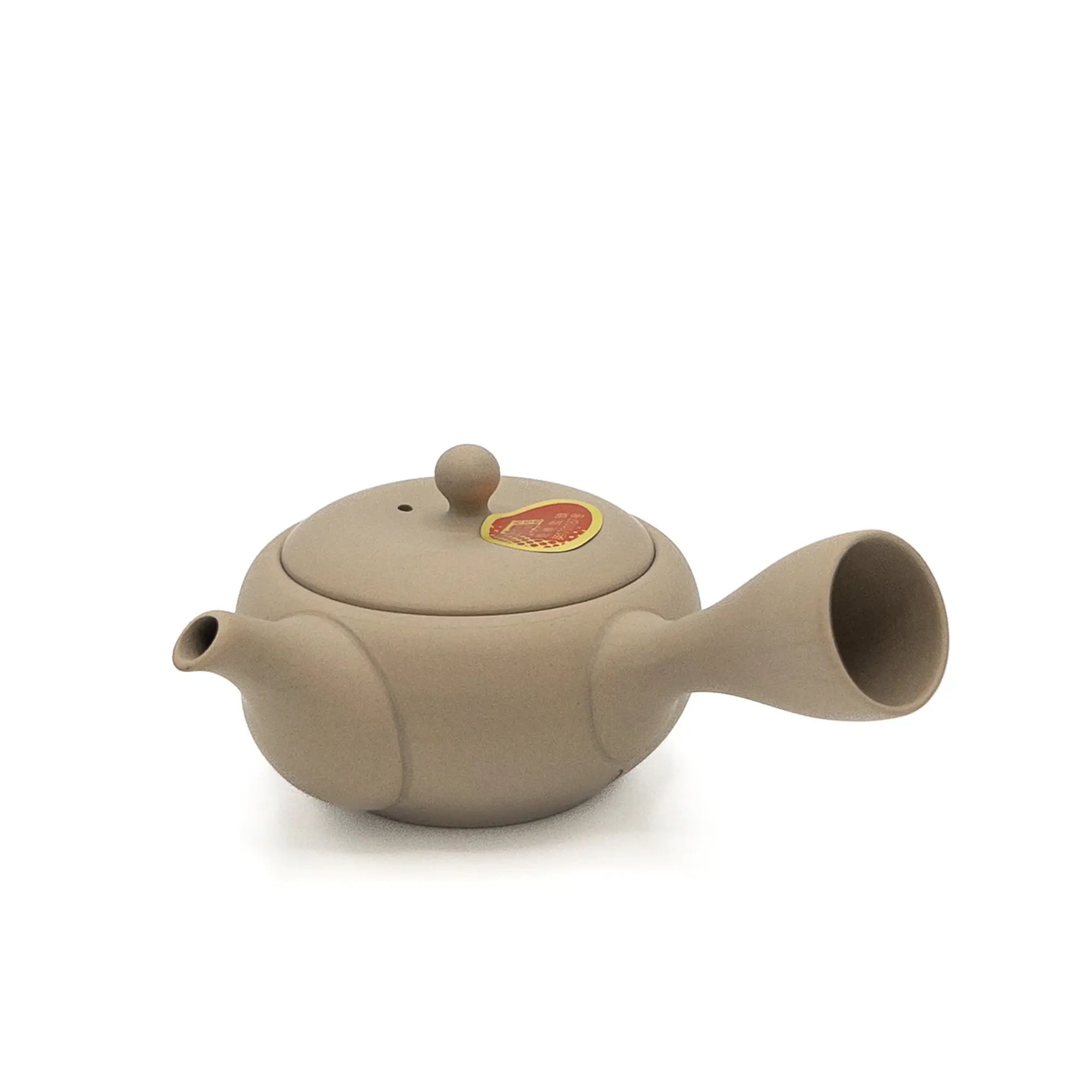 Beige Japanese teapot on a white background