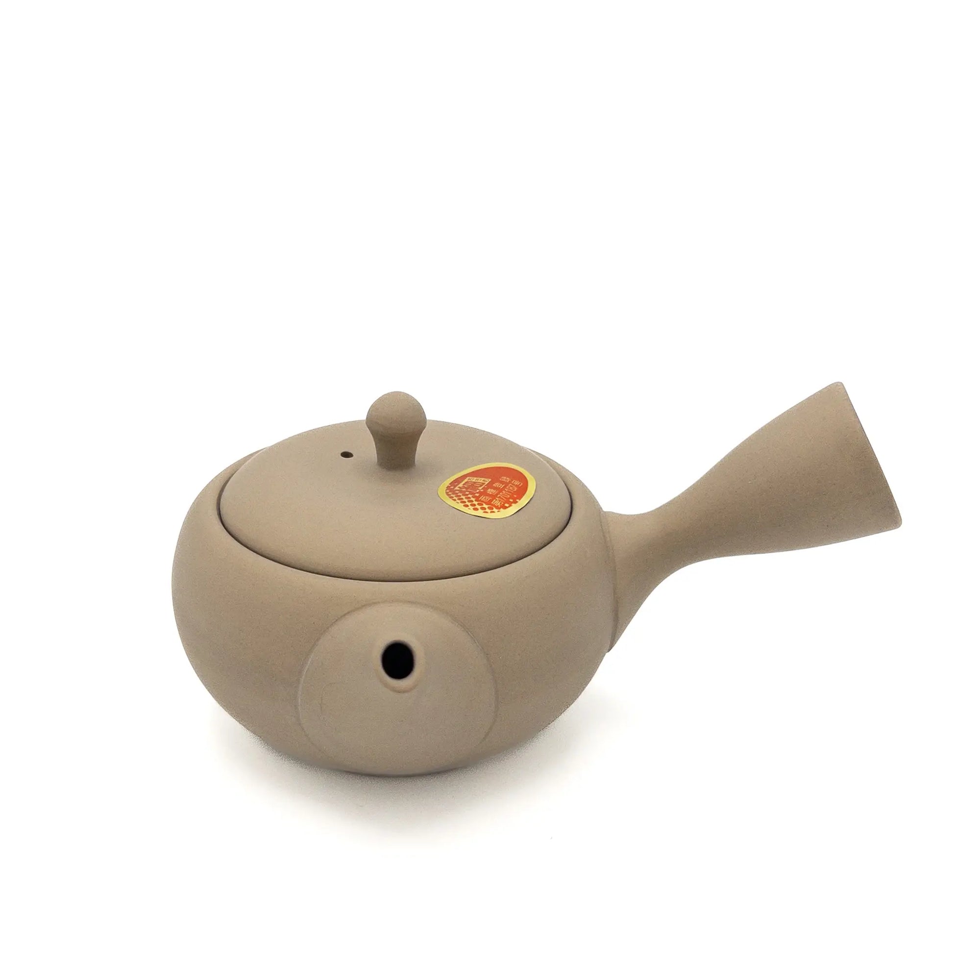 Beige Japanese teapot on a white background