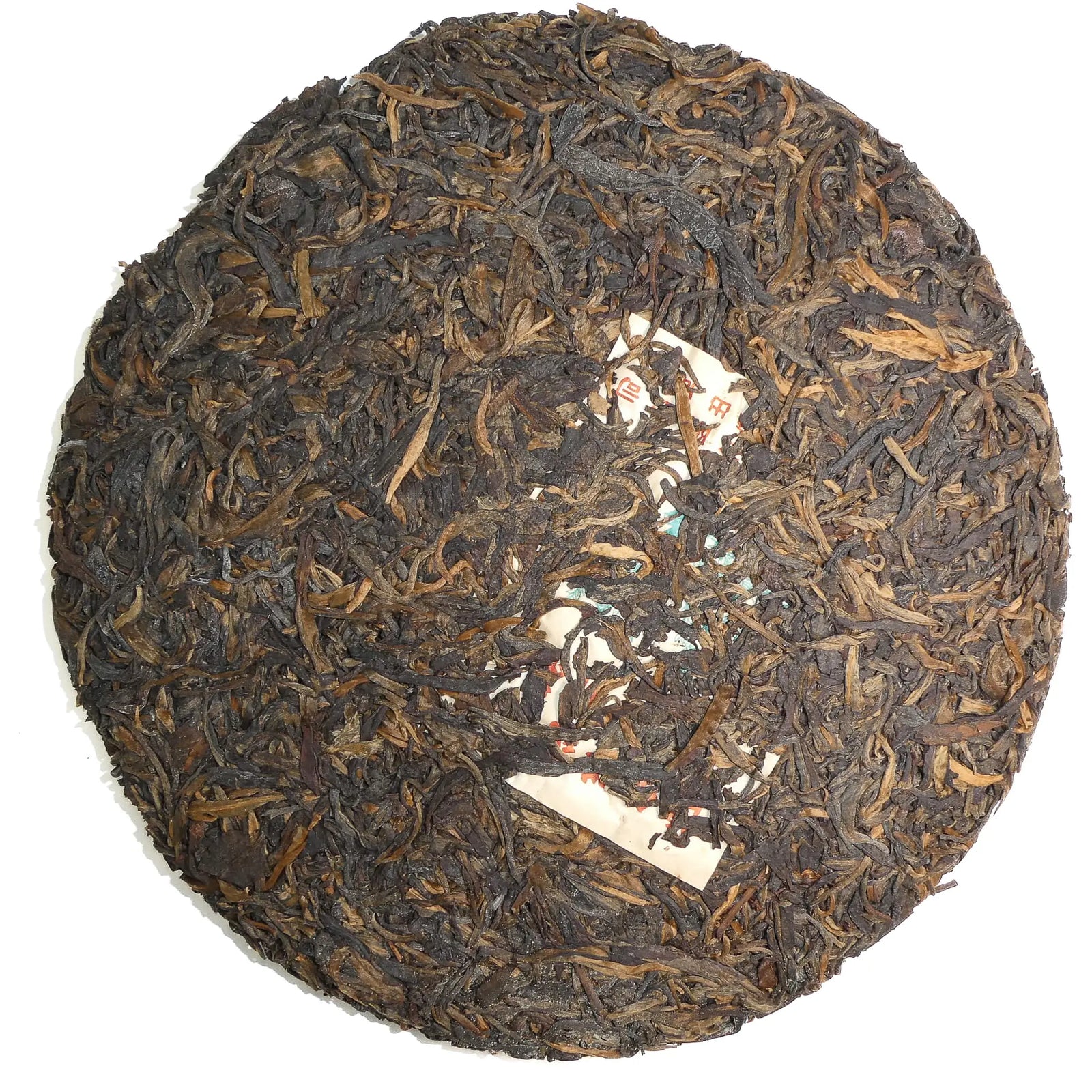 Round cake of puerh tea leaves on a white background
