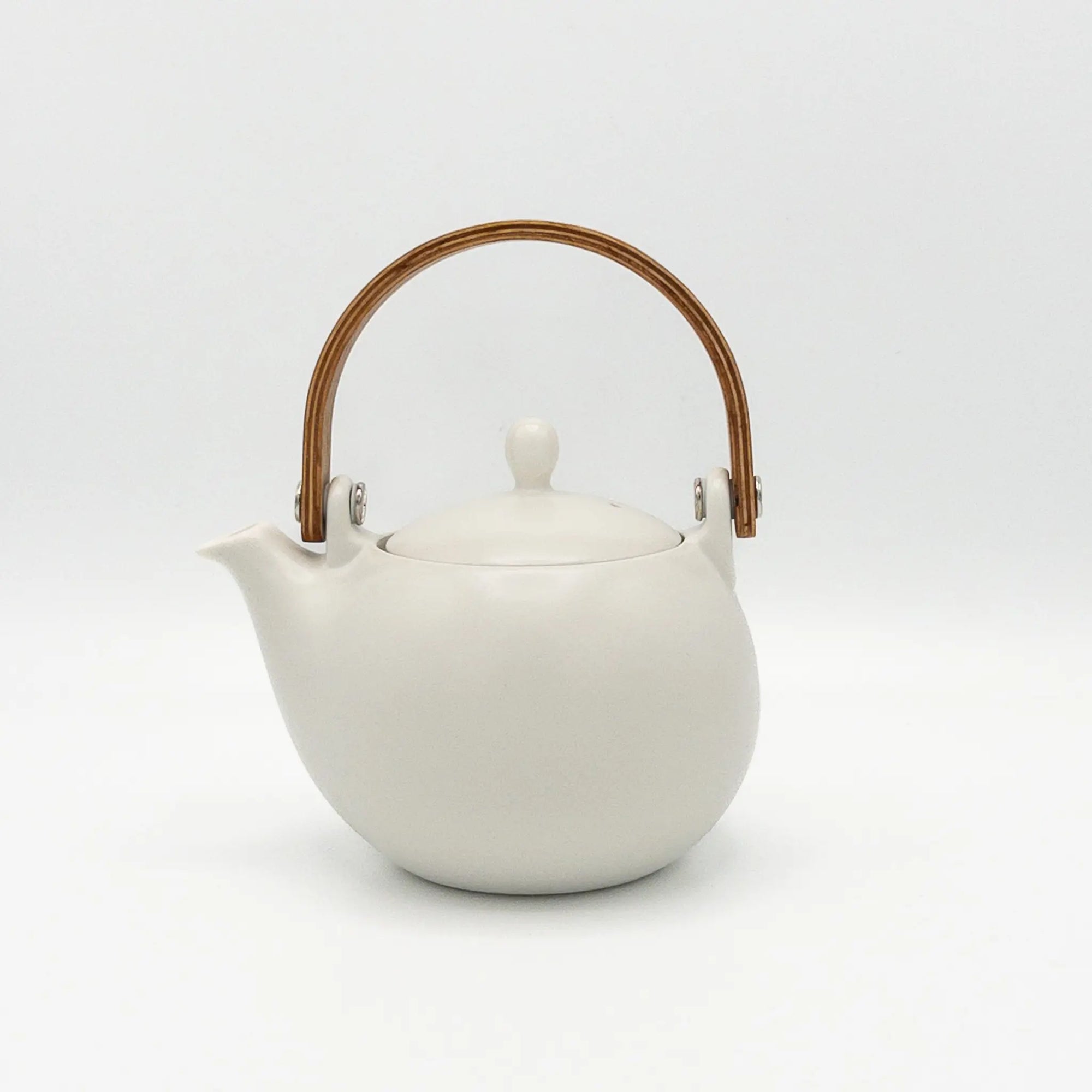 White teapot with a wooden handle on a white background
