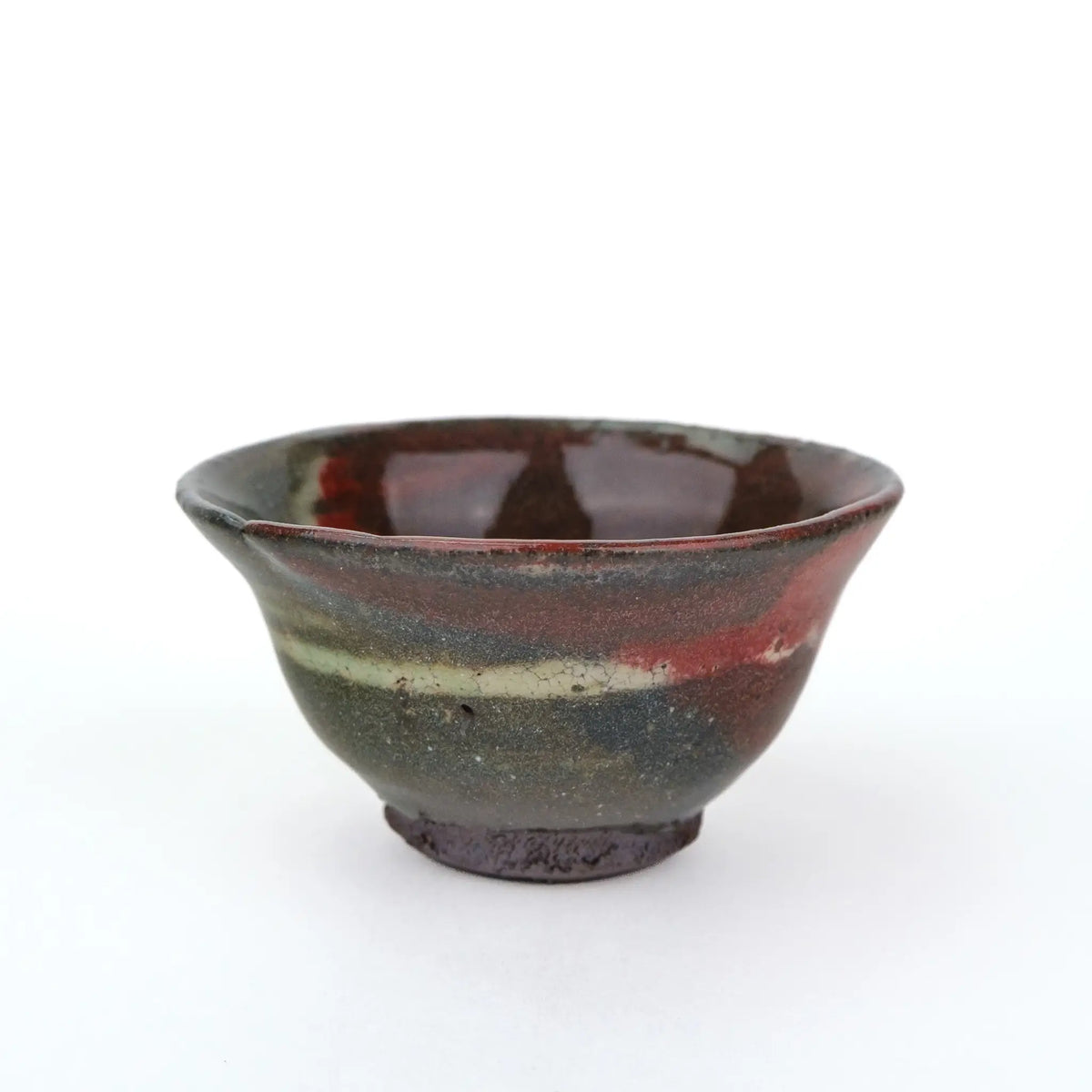 Mark Mohler gong fu cup #2C from a slightly raised angle showing a glossy dark red glaze inside and a pale band around the outside