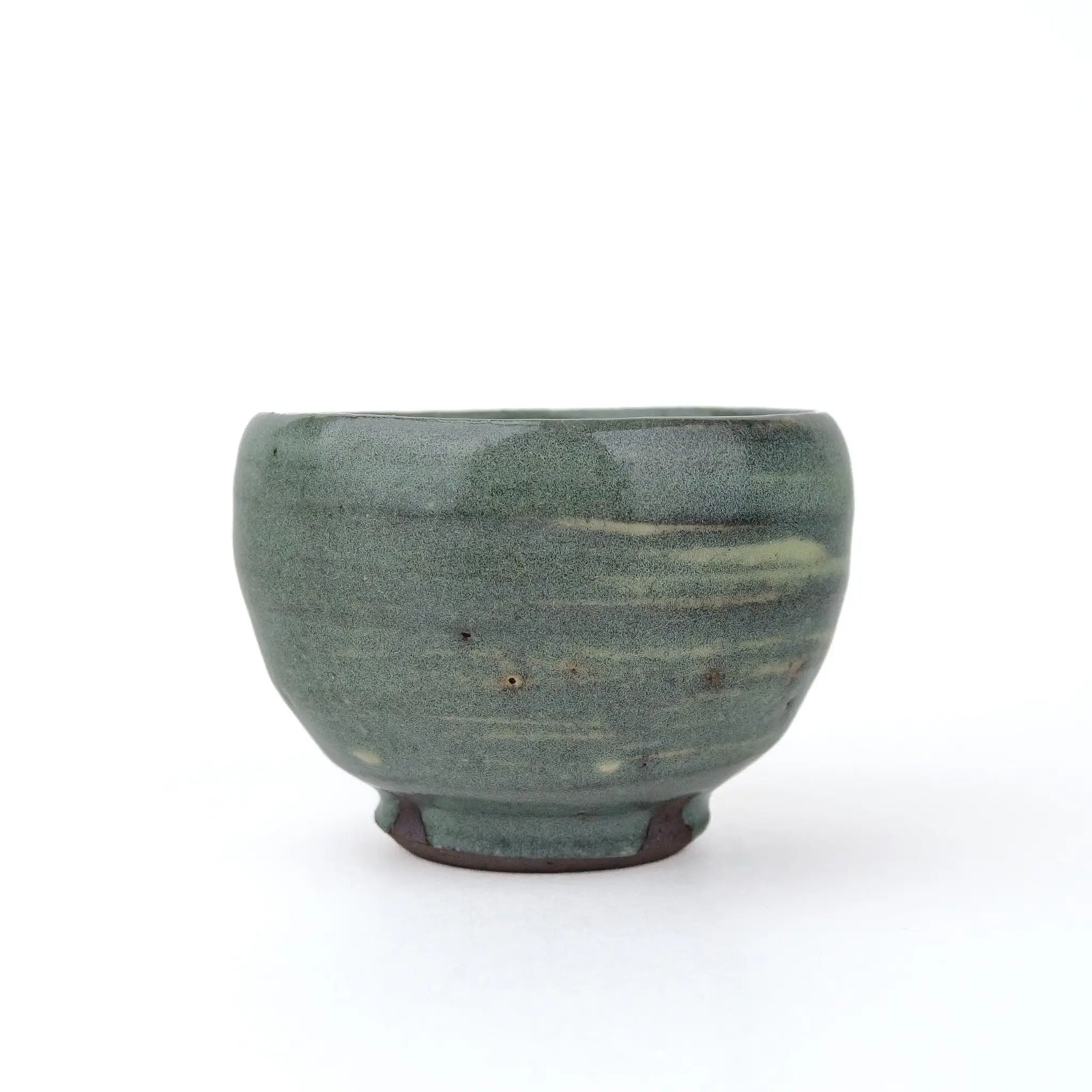 Mark Mohler handmade tea cup #B, opposite side with a mostly solid muted green glaze, a few light streaks and the unglazed foot