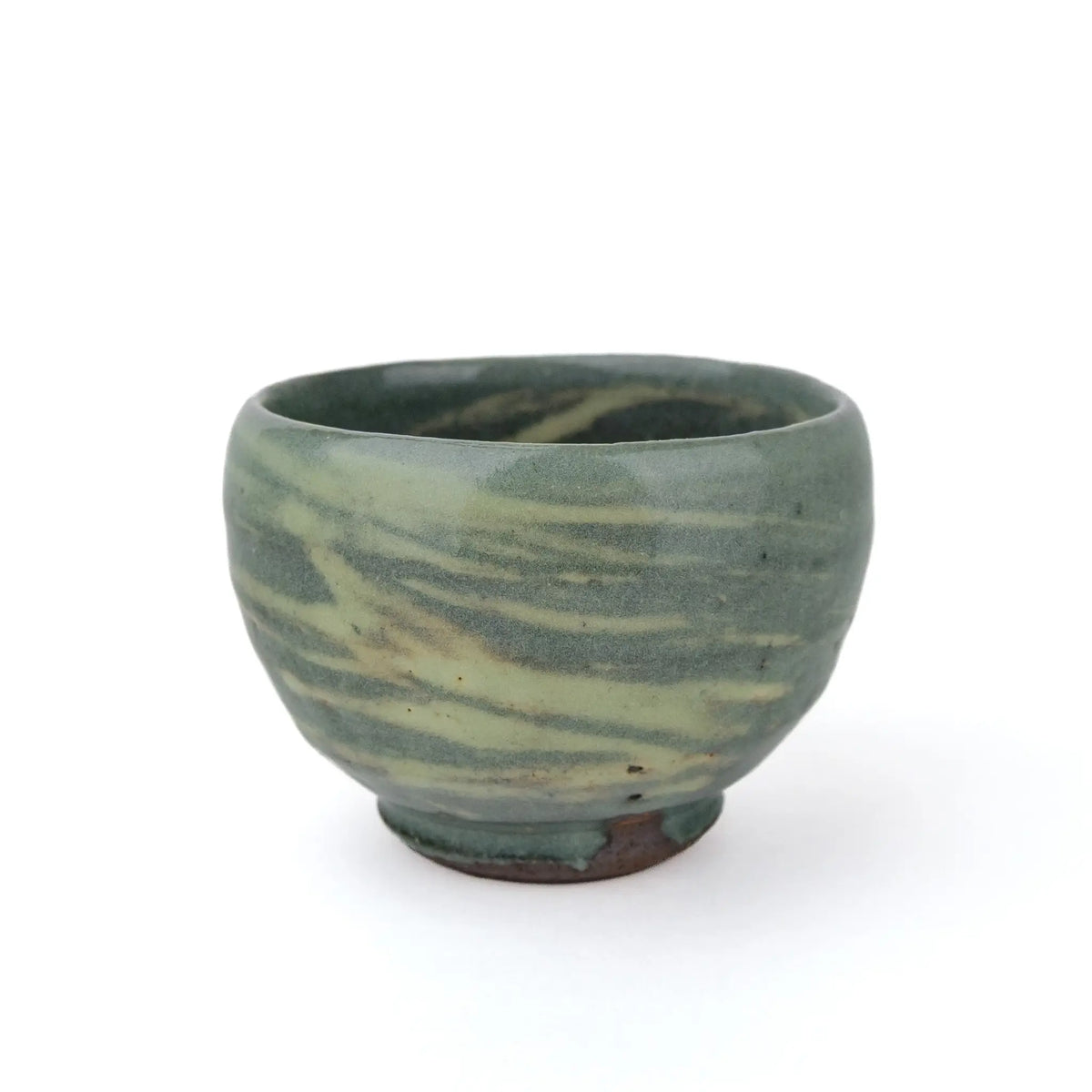 Mark Mohler handmade tea cup #B from a slightly raised angle showing swirling pale green streaks on the outside and glaze inside the rim