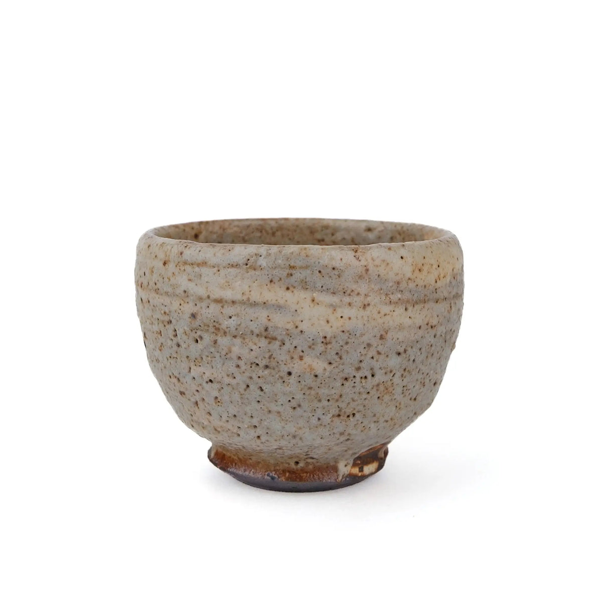 Mark Mohler handmade tea cup #N, 70 ml, side view of the rounded cup with a speckled pale glaze, throwing lines and an unglazed dark foot