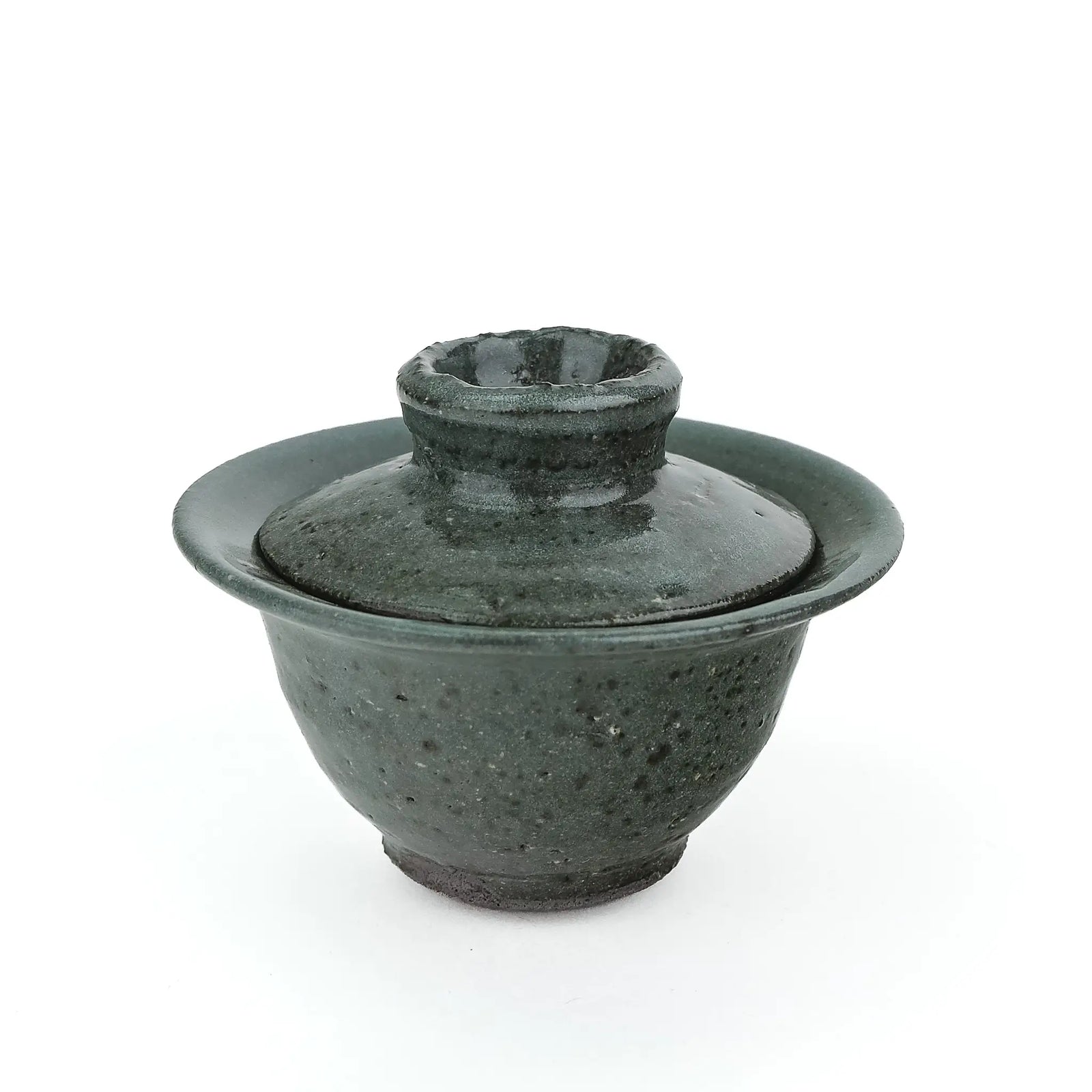 Mark Mohler handmade gaiwan #11 from a slightly raised angle with the lid in place, showing the tall knob and dark speckles in the green glaze